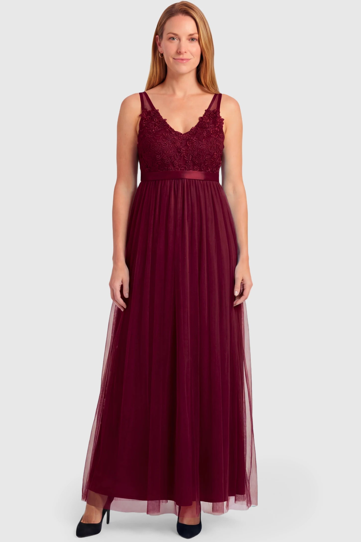 Sleeveless A-line Maternity Gown Sleeveless A-line Maternity Gown in wine red featuring lace-trimmed V-neck and empire waist on a non pregnant model.