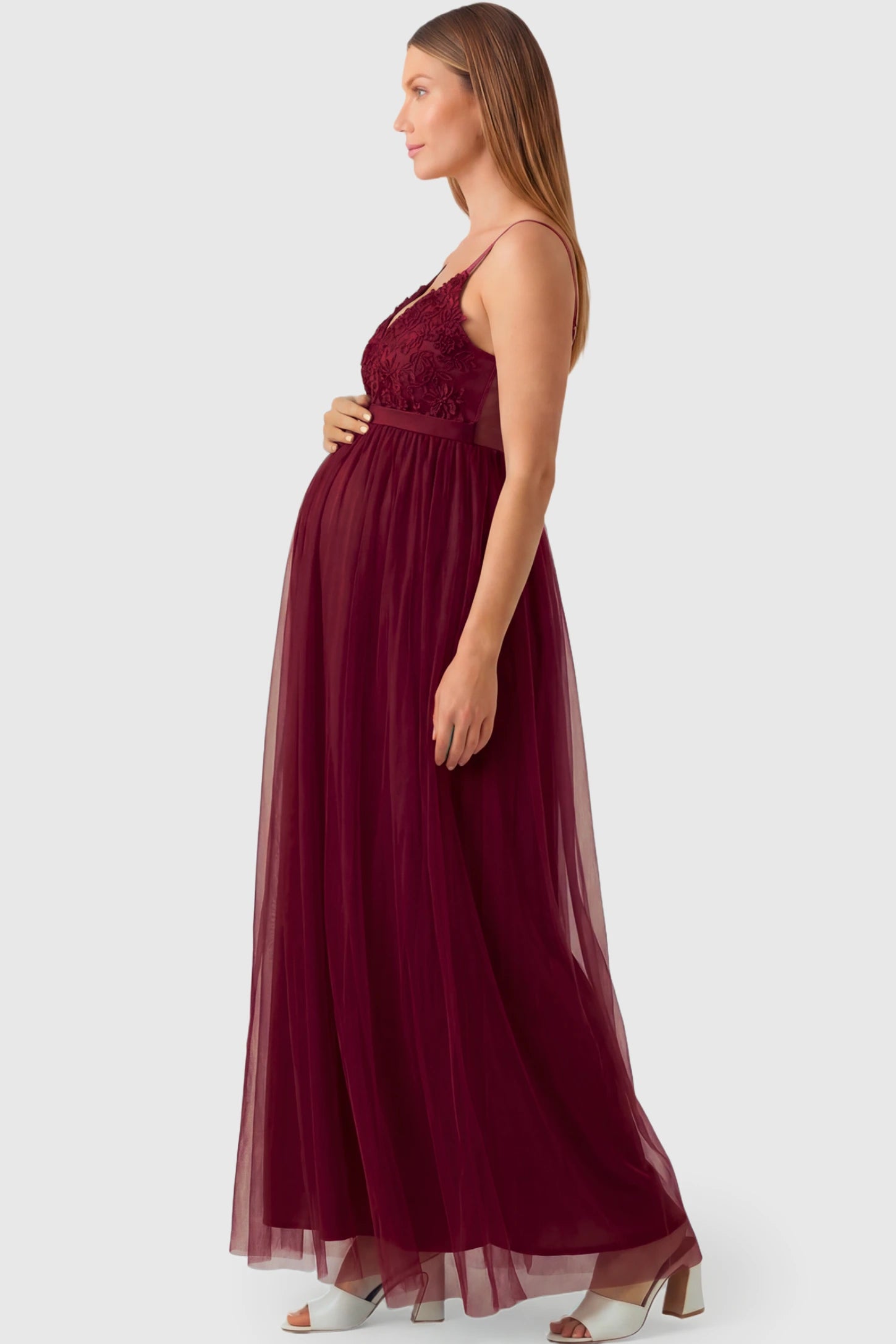 Sleeveless A-line Maternity Gown in wine red featuring lace-trimmed V-neck and empire waist on pregnant model.