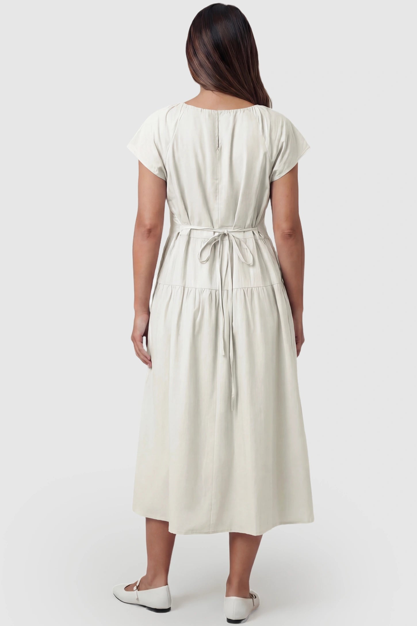 Adjustable Waist-Tie A-Line Maternity Midi Dress Adjustable waist-tie A-line maternity midi dress in beige with adjustable tie waist, back view on pregnant model