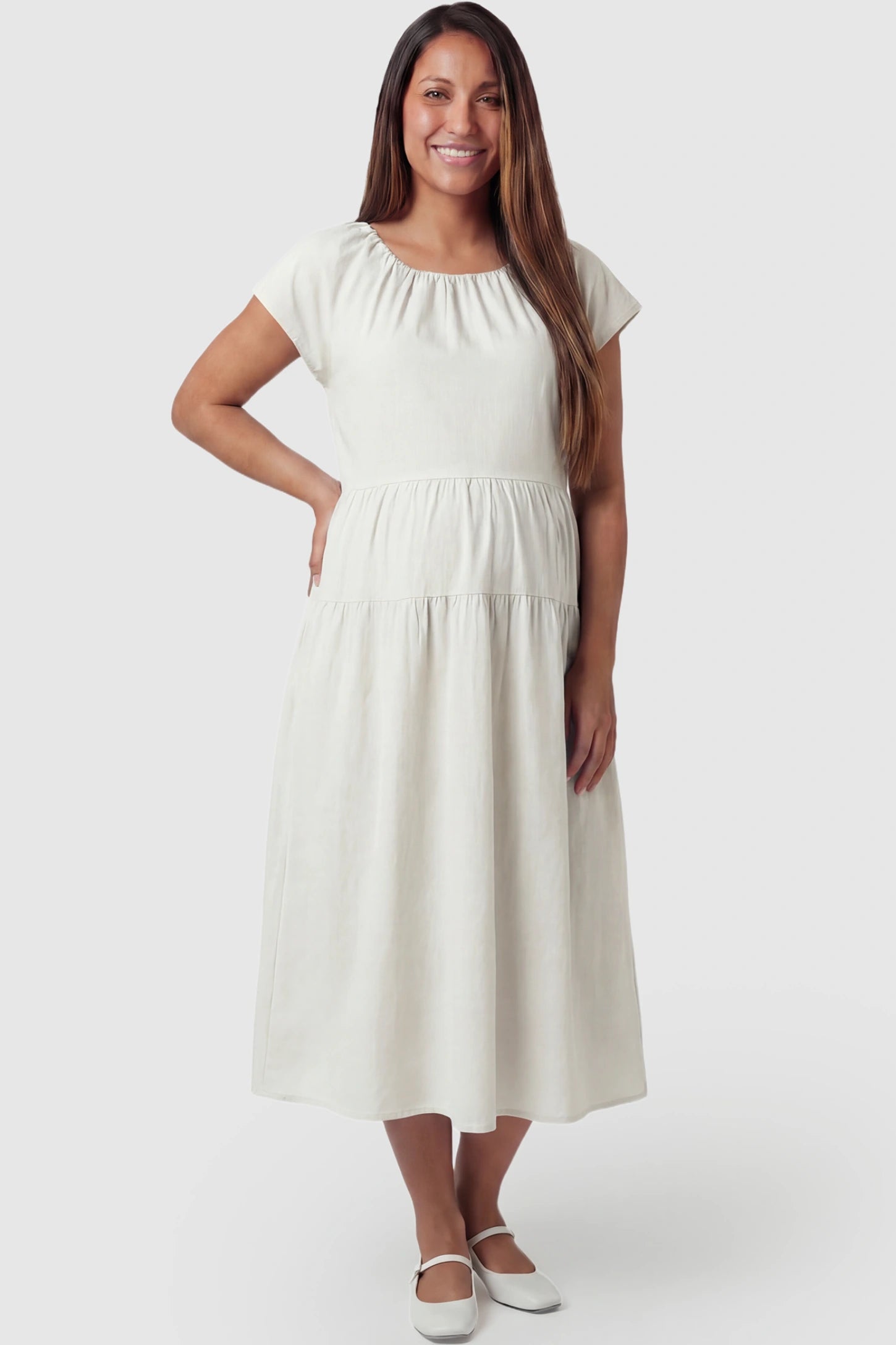 Adjustable Waist-Tie A-Line Maternity Midi Dress Adjustable waist-tie A-line maternity midi dress in beige with flowy A-line silhouette, front view on pregnant model