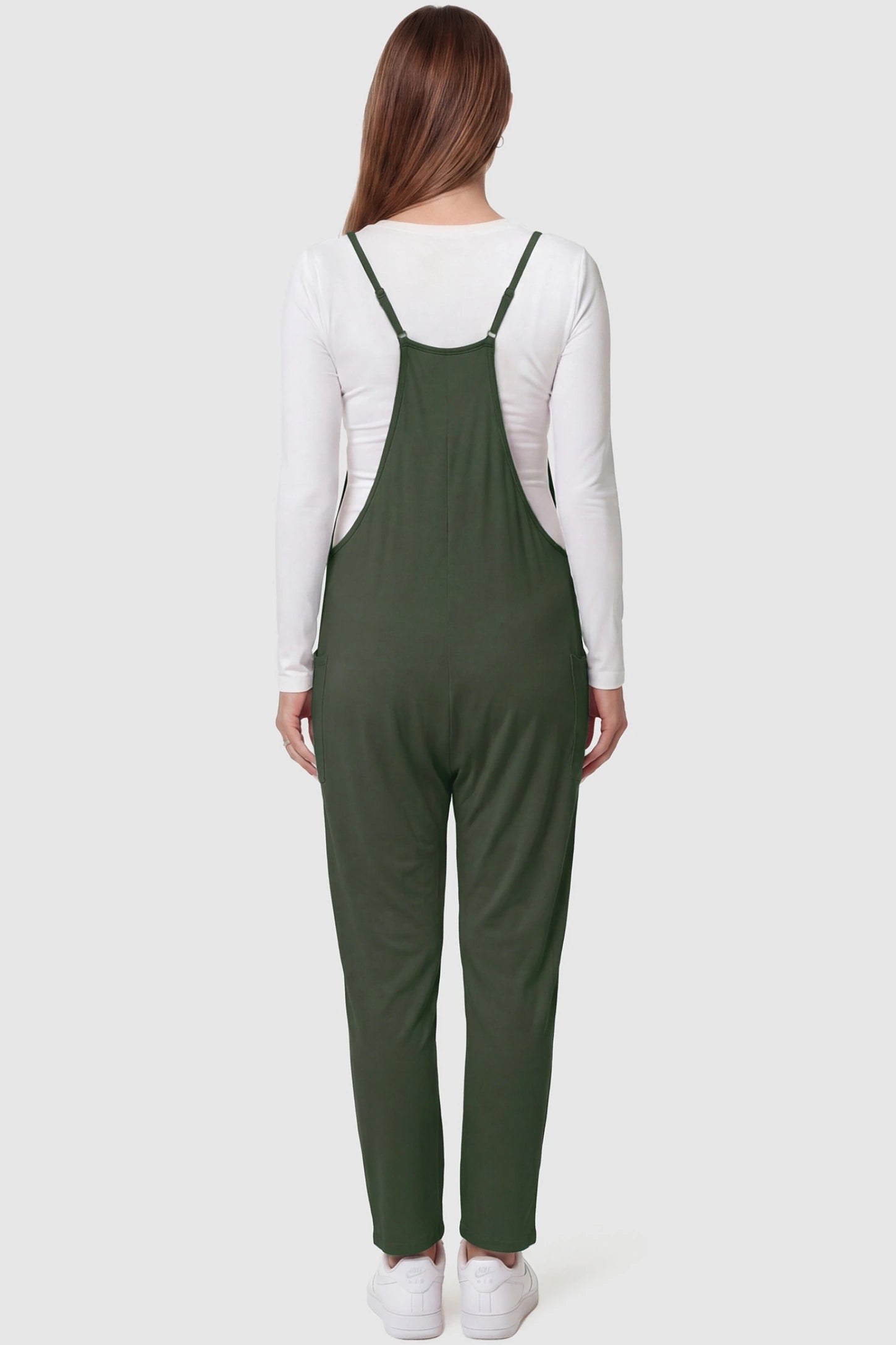Adjustable Strap Pocketed Relaxed Maternity Jumpsuit Adjustable Strap Relaxed Maternity Jumpsuit in Army Green featuring a loose fit on a pregnant model.