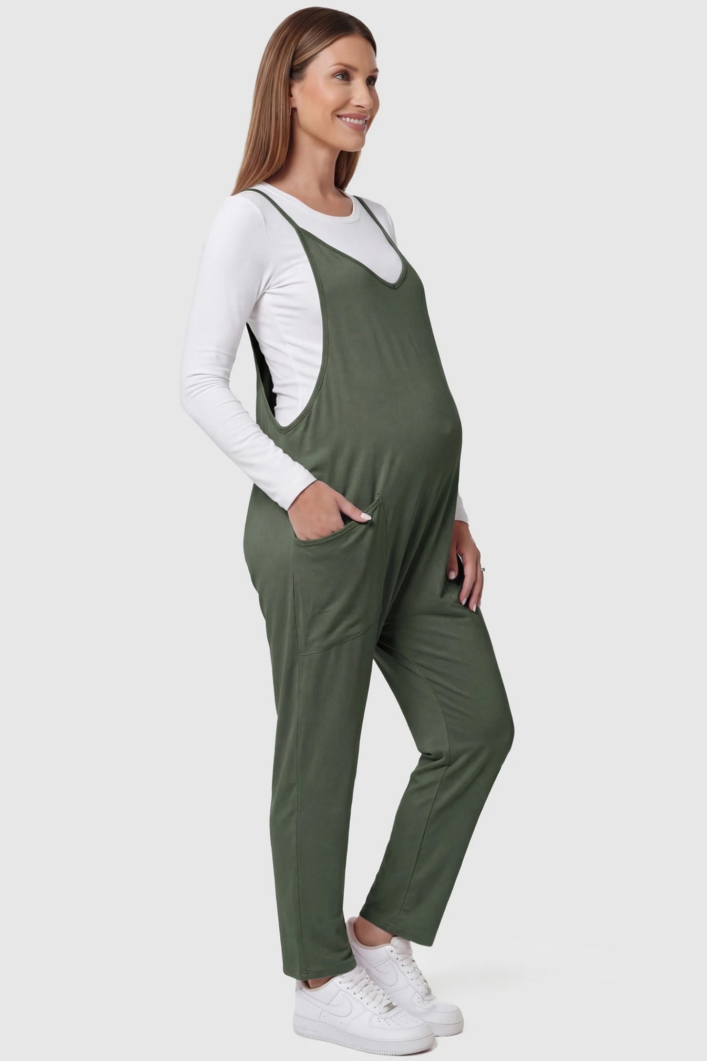 Adjustable Strap Relaxed Maternity Jumpsuit in Army Green featuring a loose fit and functional pockets on a pregnant model.