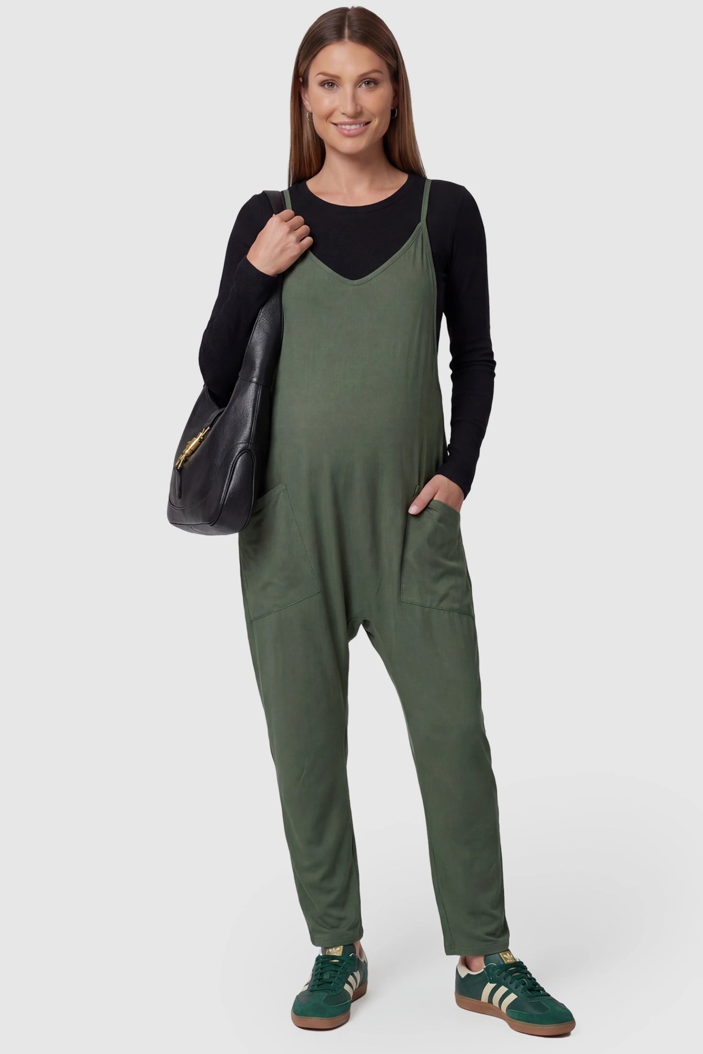 Adjustable Strap Relaxed Maternity Jumpsuit in Army Green featuring a loose fit and functional pockets on a pregnant model.