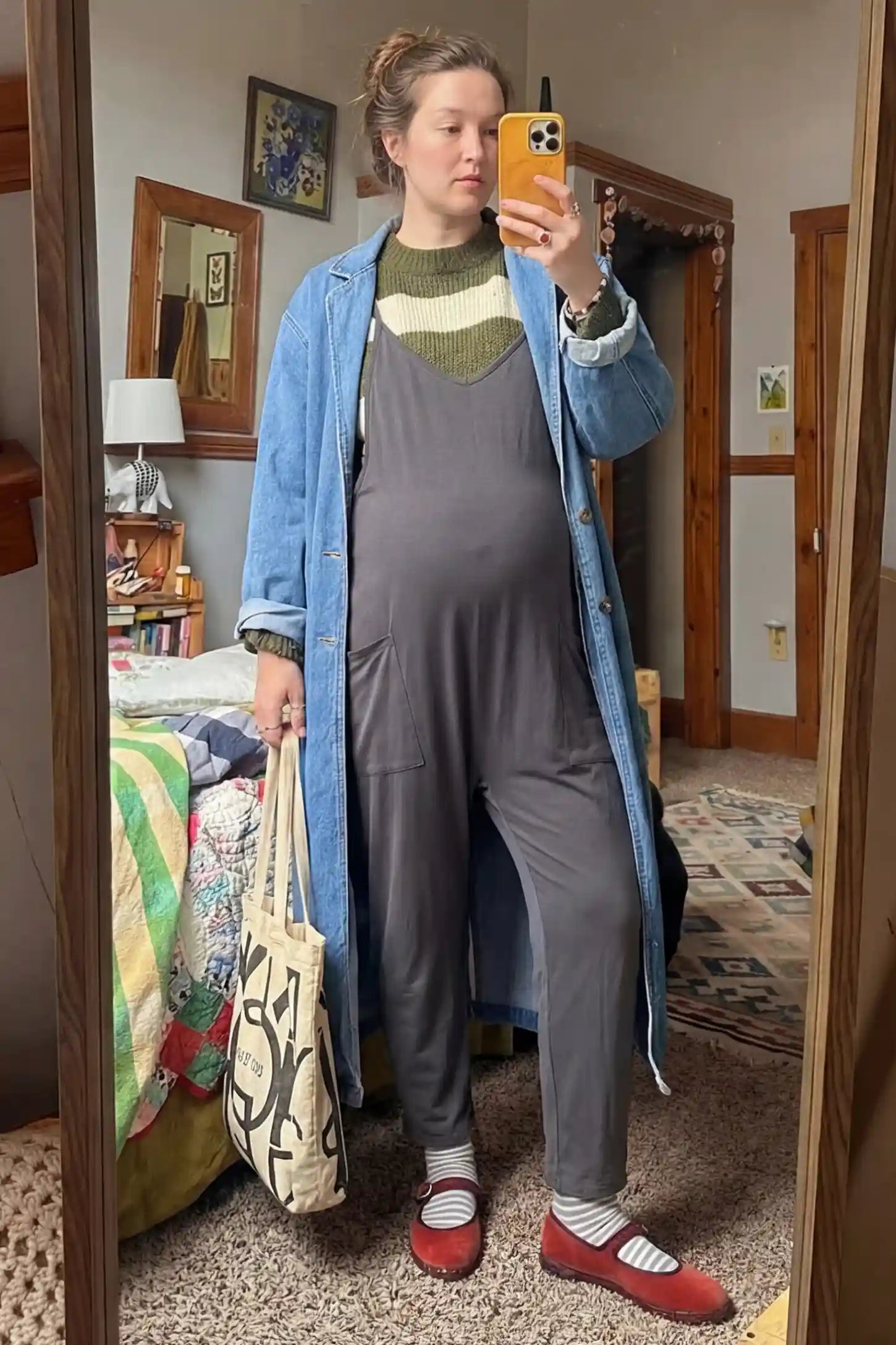 Adjustable Strap Pocketed Relaxed Maternity Jumpsuit Adjustable Strap Relaxed Maternity Jumpsuit in Dark Gray featuring a loose fit and functional pockets on a pregnant model.