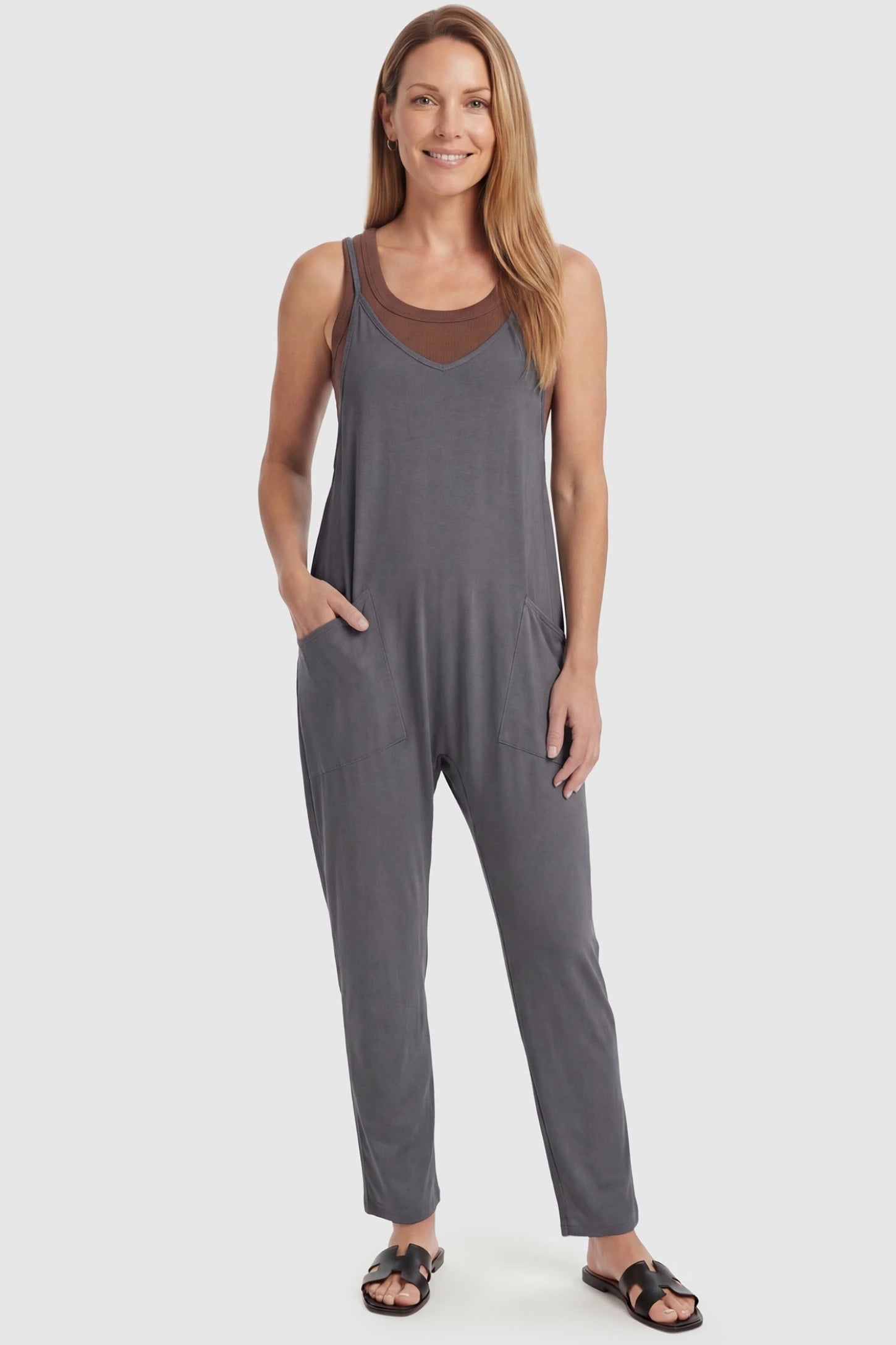 Adjustable Strap Pocketed Relaxed Maternity Jumpsuit Adjustable Strap Relaxed Maternity Jumpsuit in Dark Gray featuring a loose fit and functional pockets on a non-pregnant model.