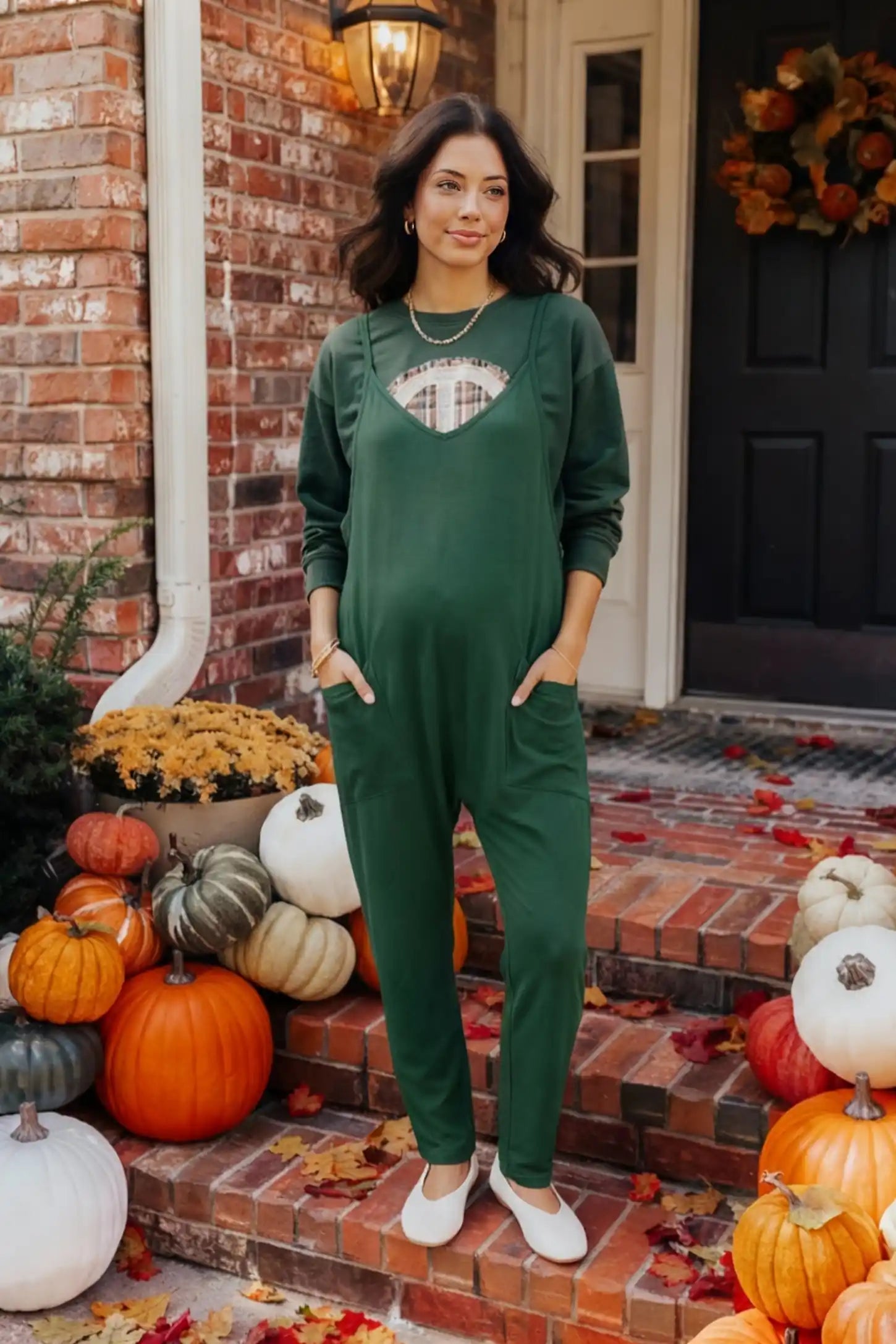 Adjustable Strap Pocketed Relaxed Maternity Jumpsuit Adjustable Strap Relaxed Maternity Jumpsuit in Dark Green featuring a loose fit and functional pockets on a pregnant model.