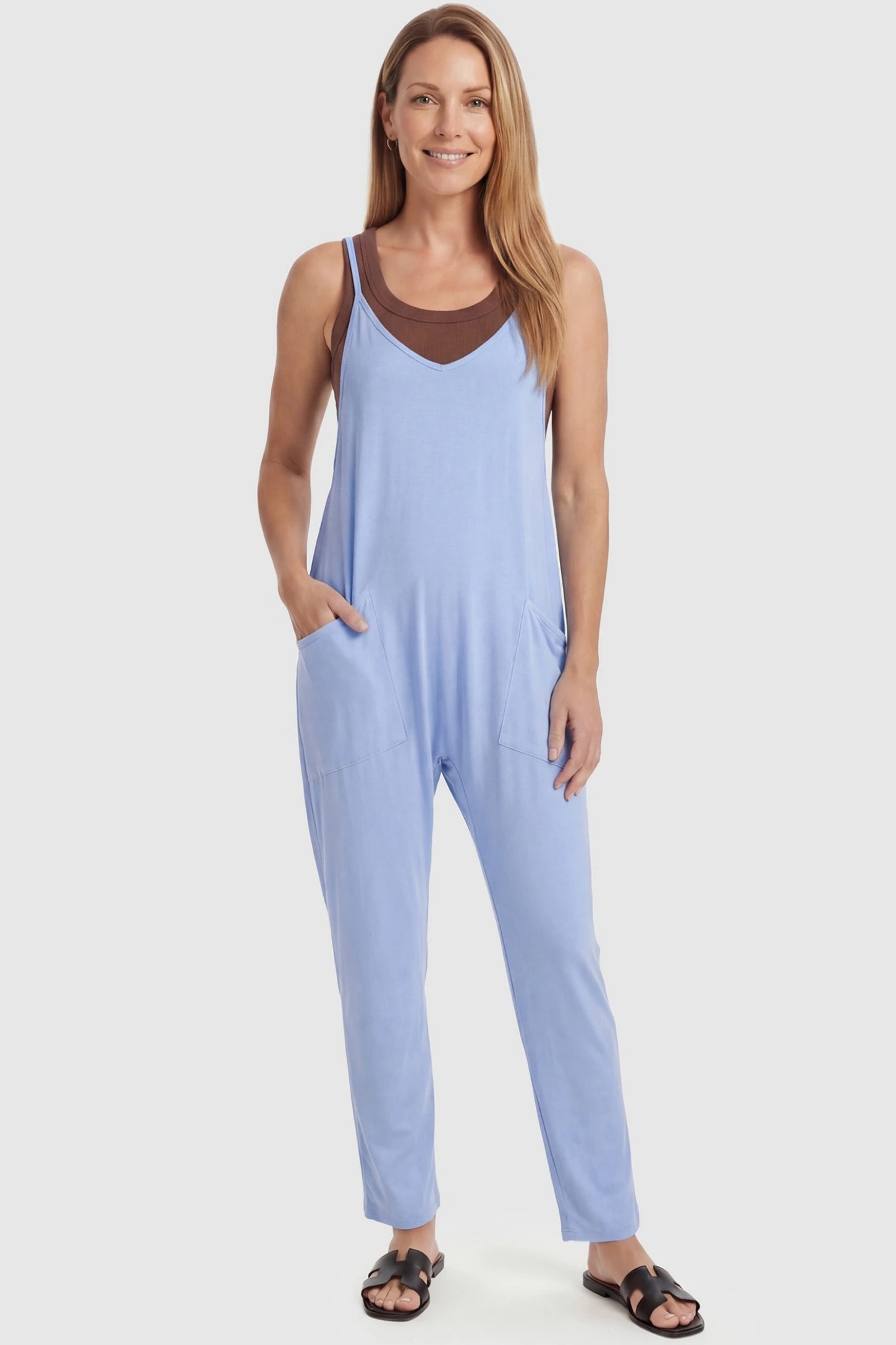 Adjustable Strap Pocketed Relaxed Maternity Jumpsuit Adjustable Strap Relaxed Maternity Jumpsuit in Light Blue featuring a loose fit and functional pockets on a non-pregnant model.