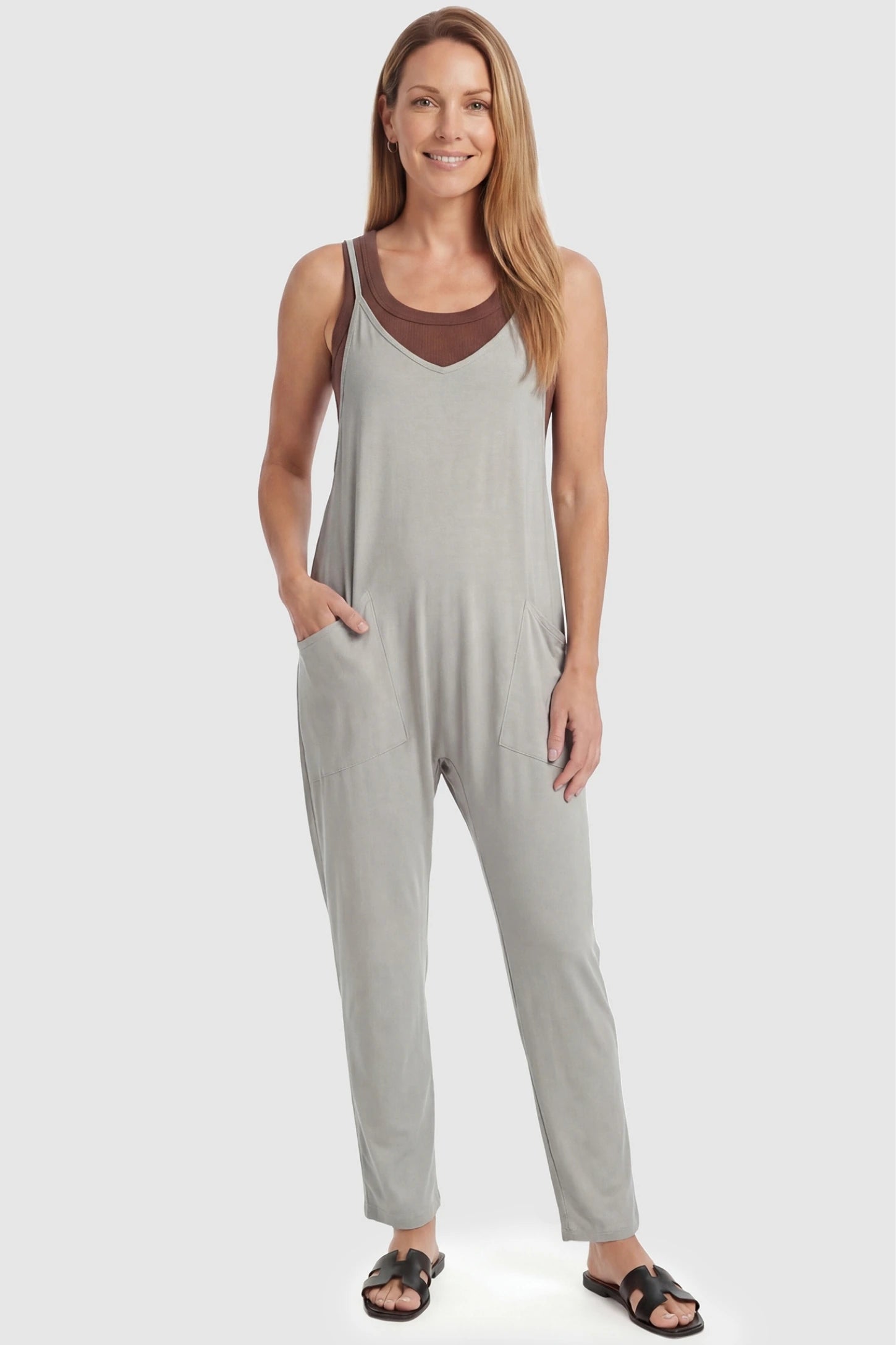 Adjustable Strap Pocketed Relaxed Maternity Jumpsuit Adjustable Strap Relaxed Maternity Jumpsuit in Light Gray featuring a loose fit and functional pockets on a non-pregnant model.