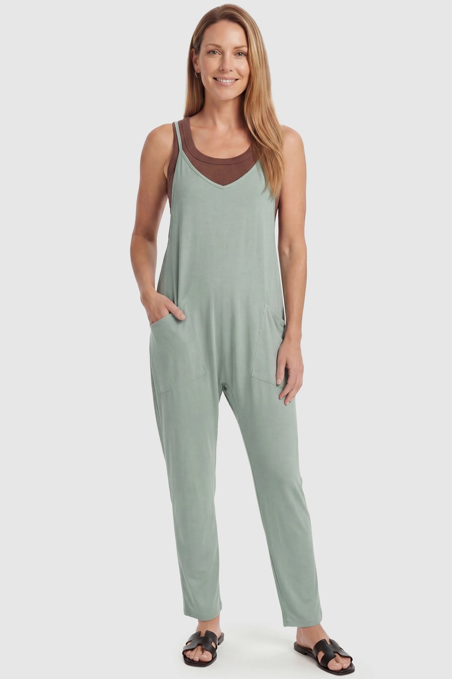 Adjustable Strap Pocketed Relaxed Maternity Jumpsuit Adjustable Strap Relaxed Maternity Jumpsuit in Light Green featuring a loose fit and functional pockets on a non-pregnant model.
