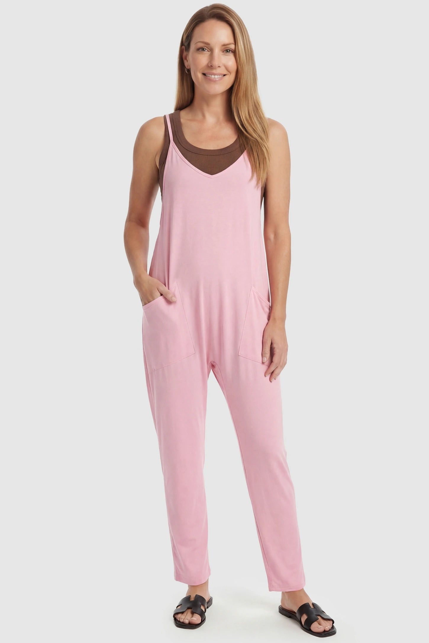 Adjustable Strap Pocketed Relaxed Maternity Jumpsuit Adjustable Strap Relaxed Maternity Jumpsuit in Pink featuring a loose fit and functional pockets on a non-pregnant model.
