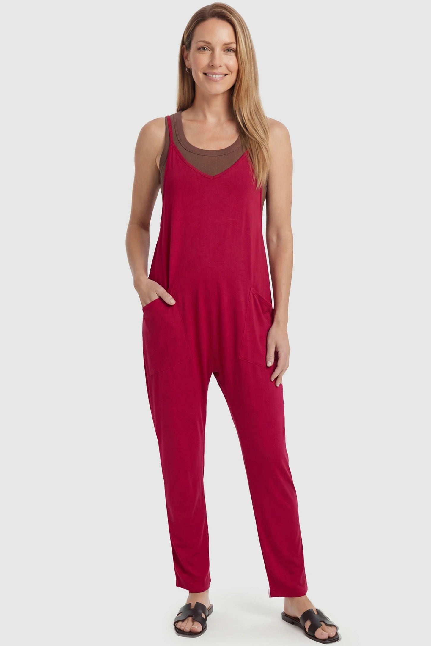 Adjustable Strap Pocketed Relaxed Maternity Jumpsuit Adjustable Strap Relaxed Maternity Jumpsuit in Wine Red featuring a loose fit and functional pockets on a non-pregnant model.