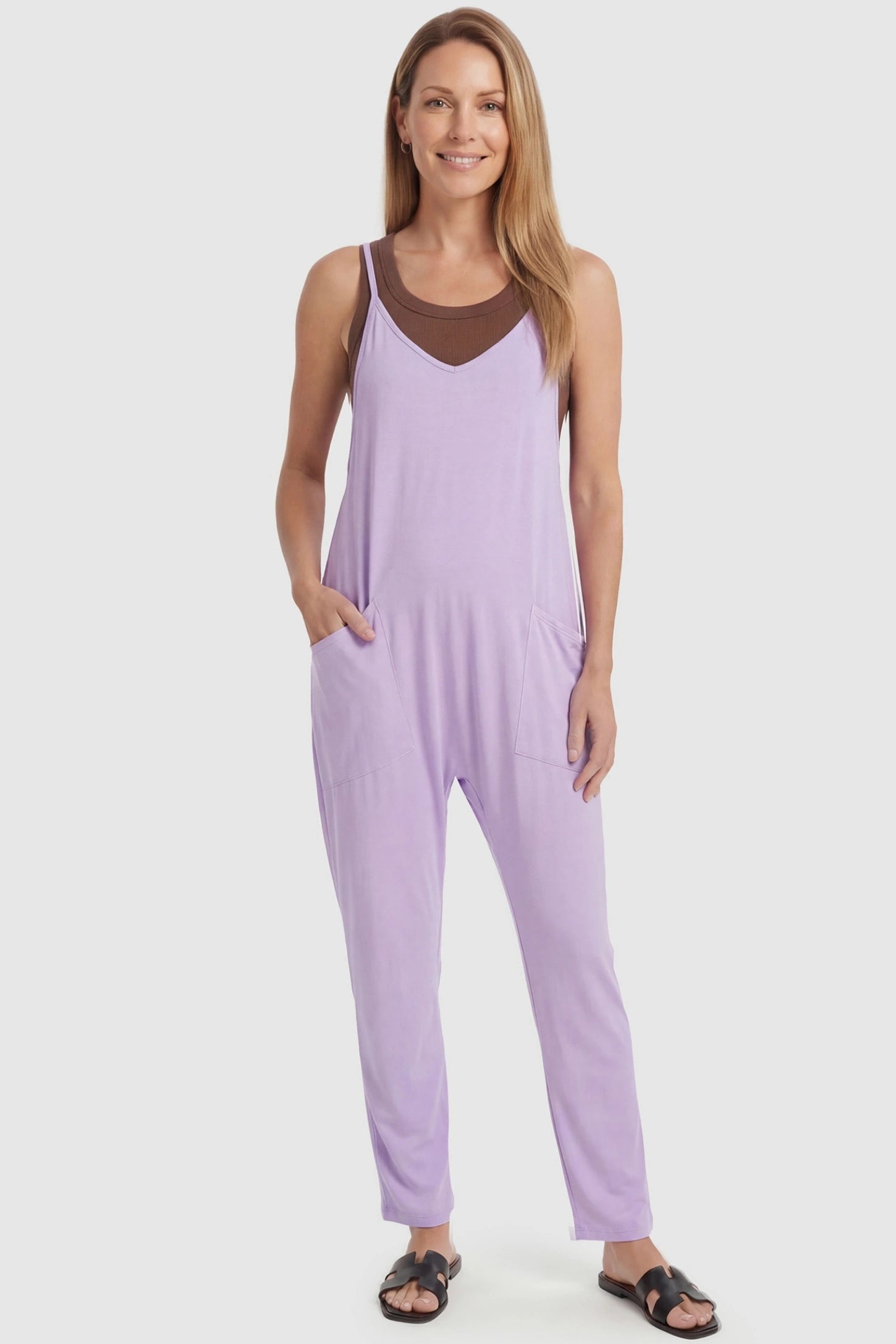 Adjustable Strap Pocketed Relaxed Maternity Jumpsuit Adjustable Strap Relaxed Maternity Jumpsuit in Purple featuring a loose fit and functional pockets on a non-pregnant model.