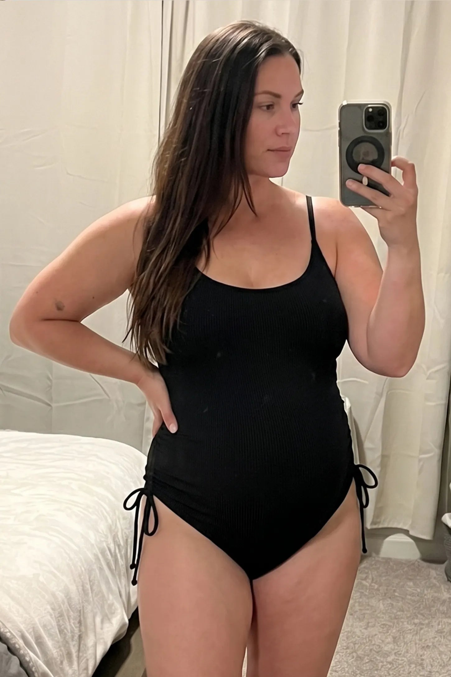 Side-Ruched Scoop Neck Maternity One-Piece Side-ruched scoop neck maternity one-piece in black with scoop neckline and side tie, front view on pregnant model