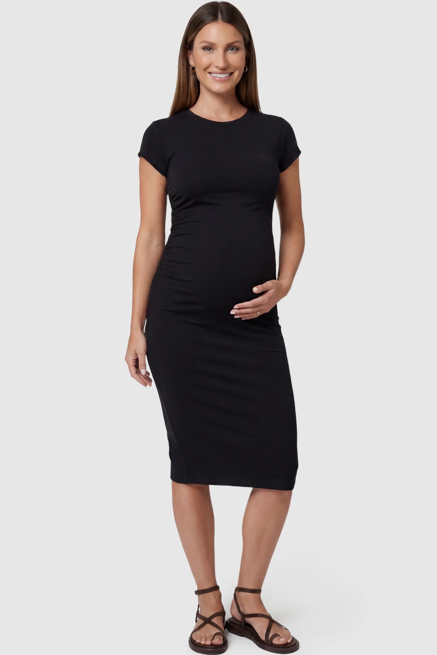 Basic round neck maternity midi dress in black with classic round neckline, front view on pregnant model