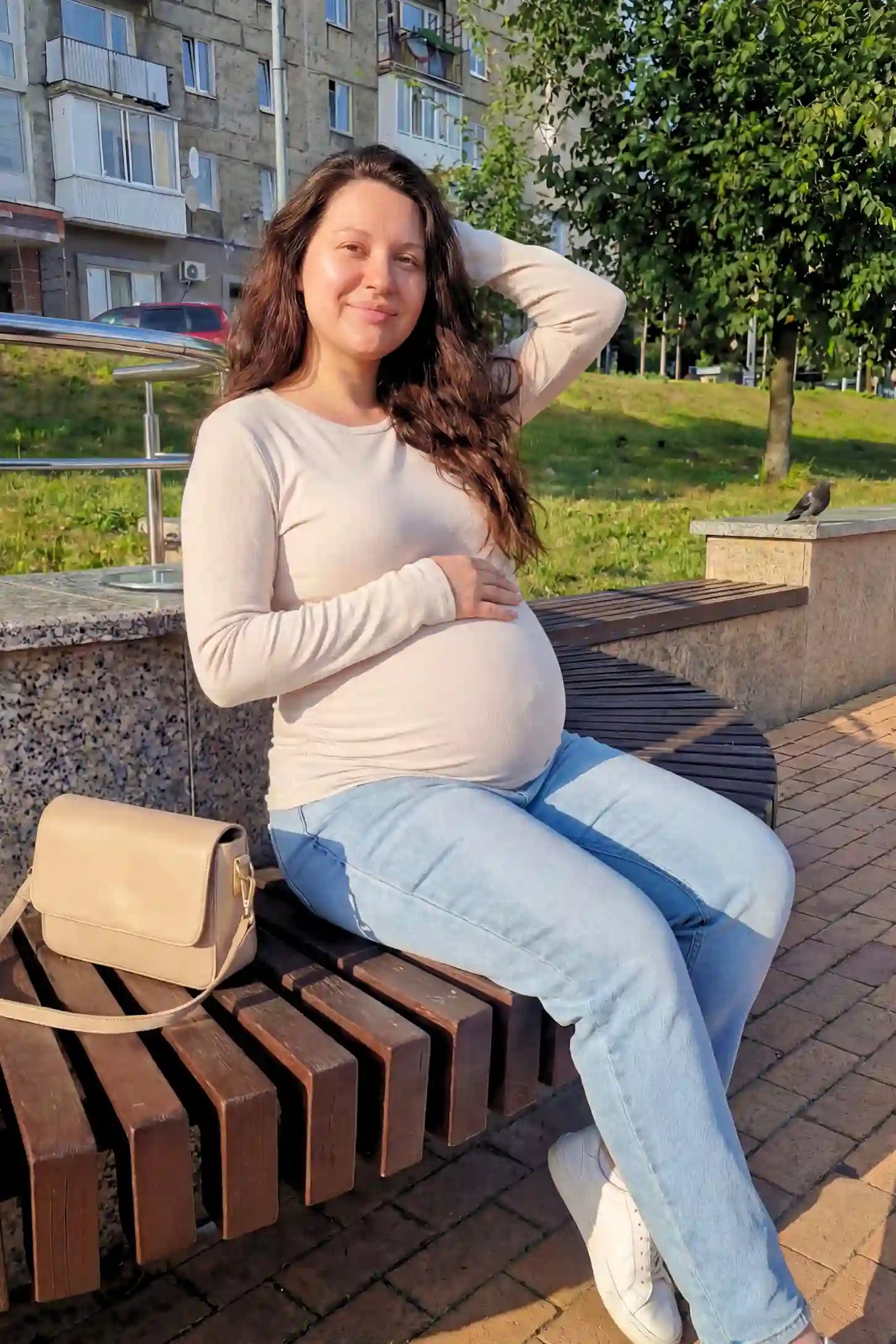 Basic Long Sleeve Maternity Top Basic Long Sleeve Maternity Top in beige featuring a soft crew neck and lightweight stretch fabric on a pregnant model.