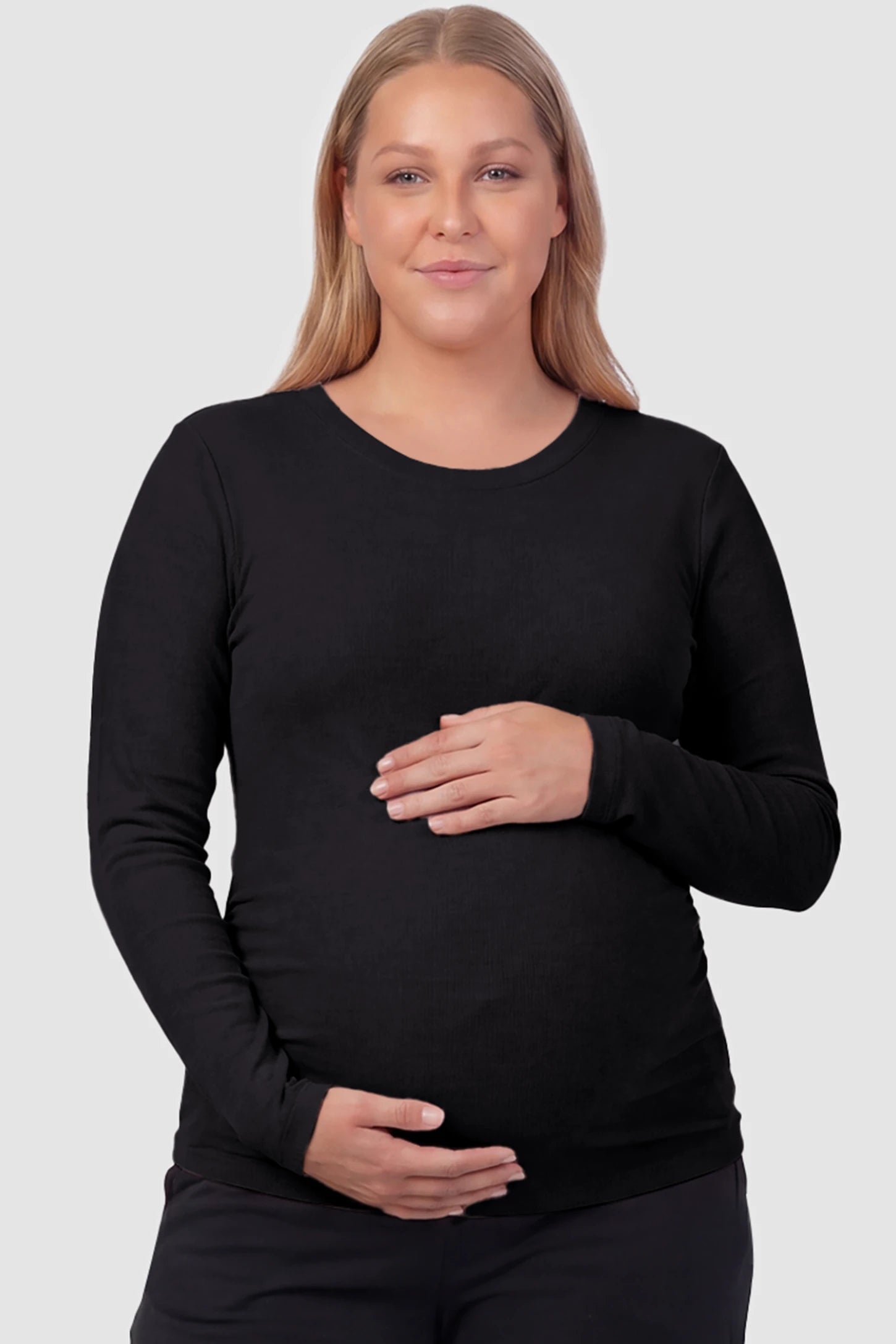 Basic Long Sleeve Maternity Top Basic Long Sleeve Maternity Top in black featuring a soft crew neck and lightweight stretch fabric on a plus size pregnant model, front view