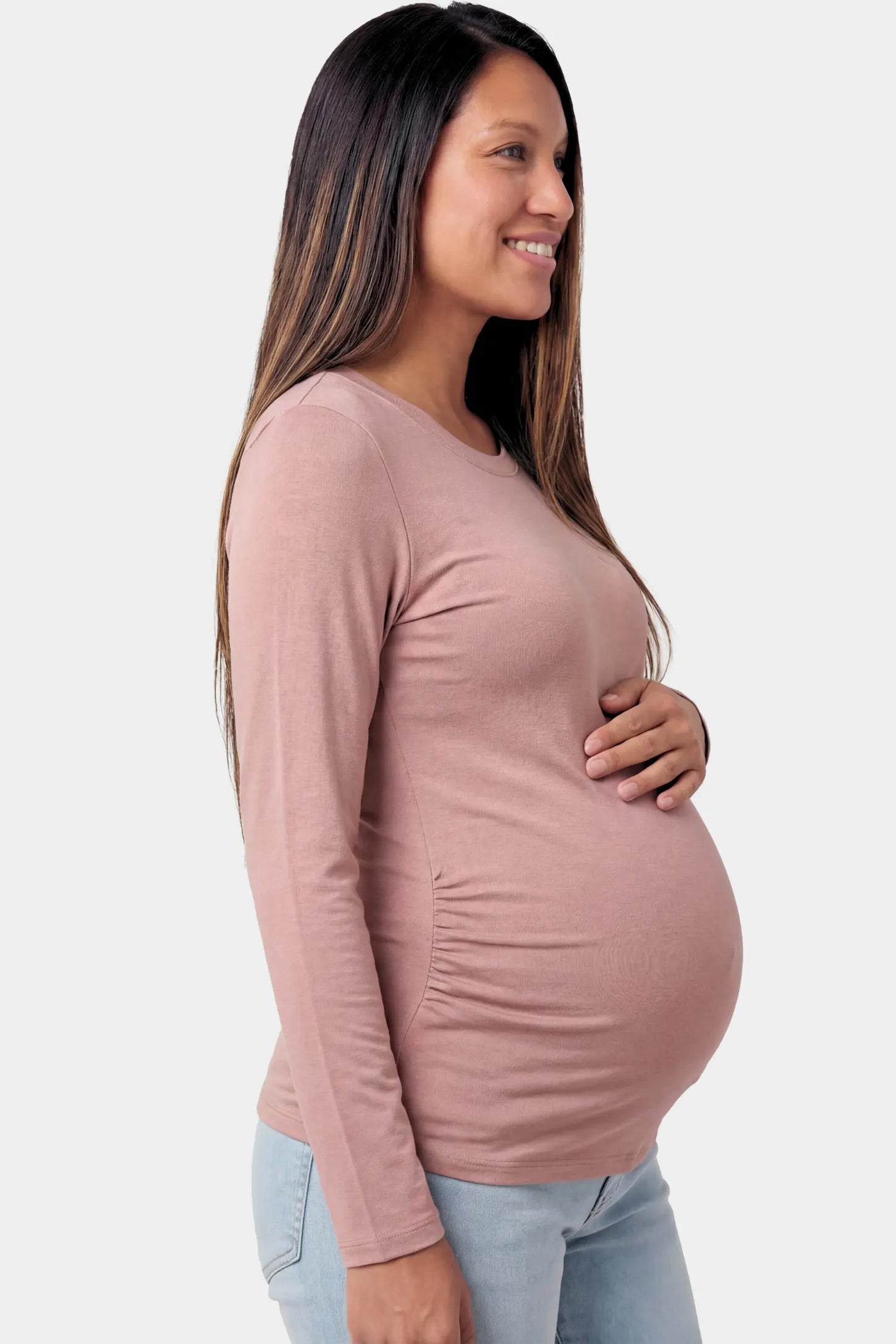 Basic Long Sleeve Maternity Top Basic Long Sleeve Maternity Top in light brown featuring a soft crew neck and lightweight stretch fabric on a pregnant model.