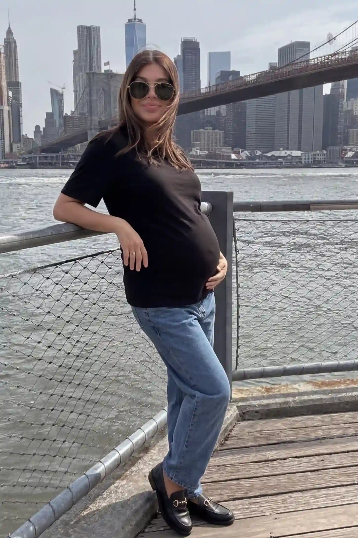 Basic One-Sided Slit Short Sleeve Maternity Top Basic one-sided slit short sleeve maternity top in black with short sleeves, side view on pregnant model