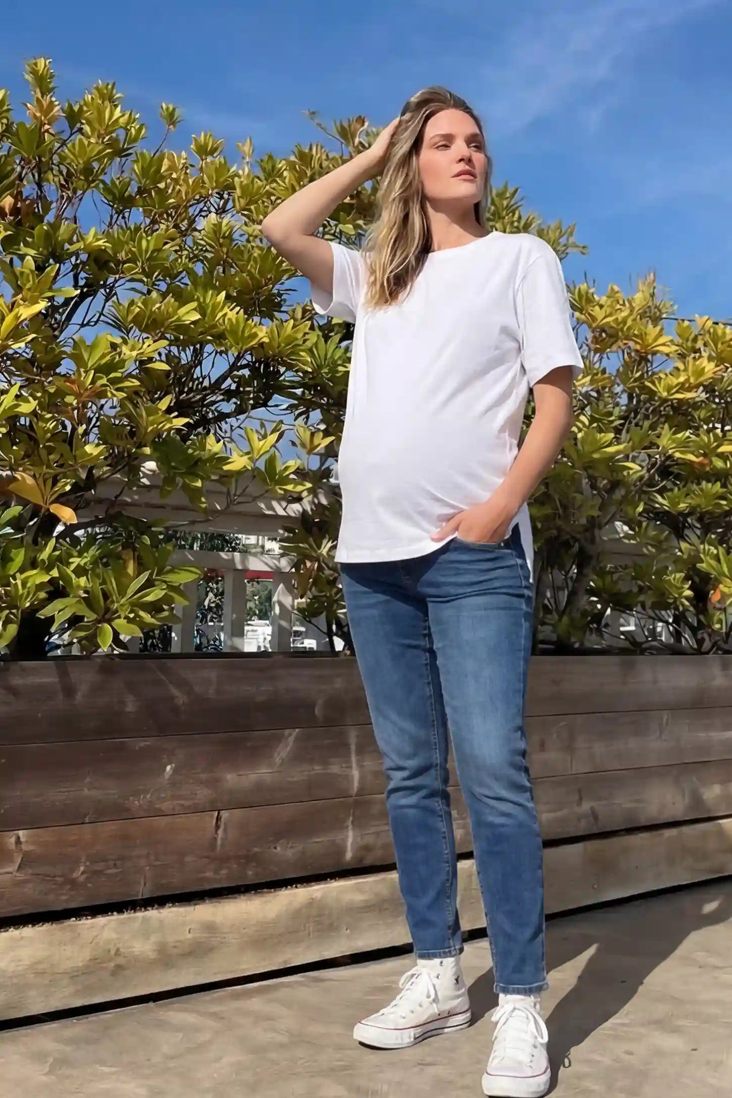 Basic One-Sided Slit Short Sleeve Maternity Top Basic one-sided slit short sleeve maternity top in white with classic round neckline and short sleeves, front view on pregnant model