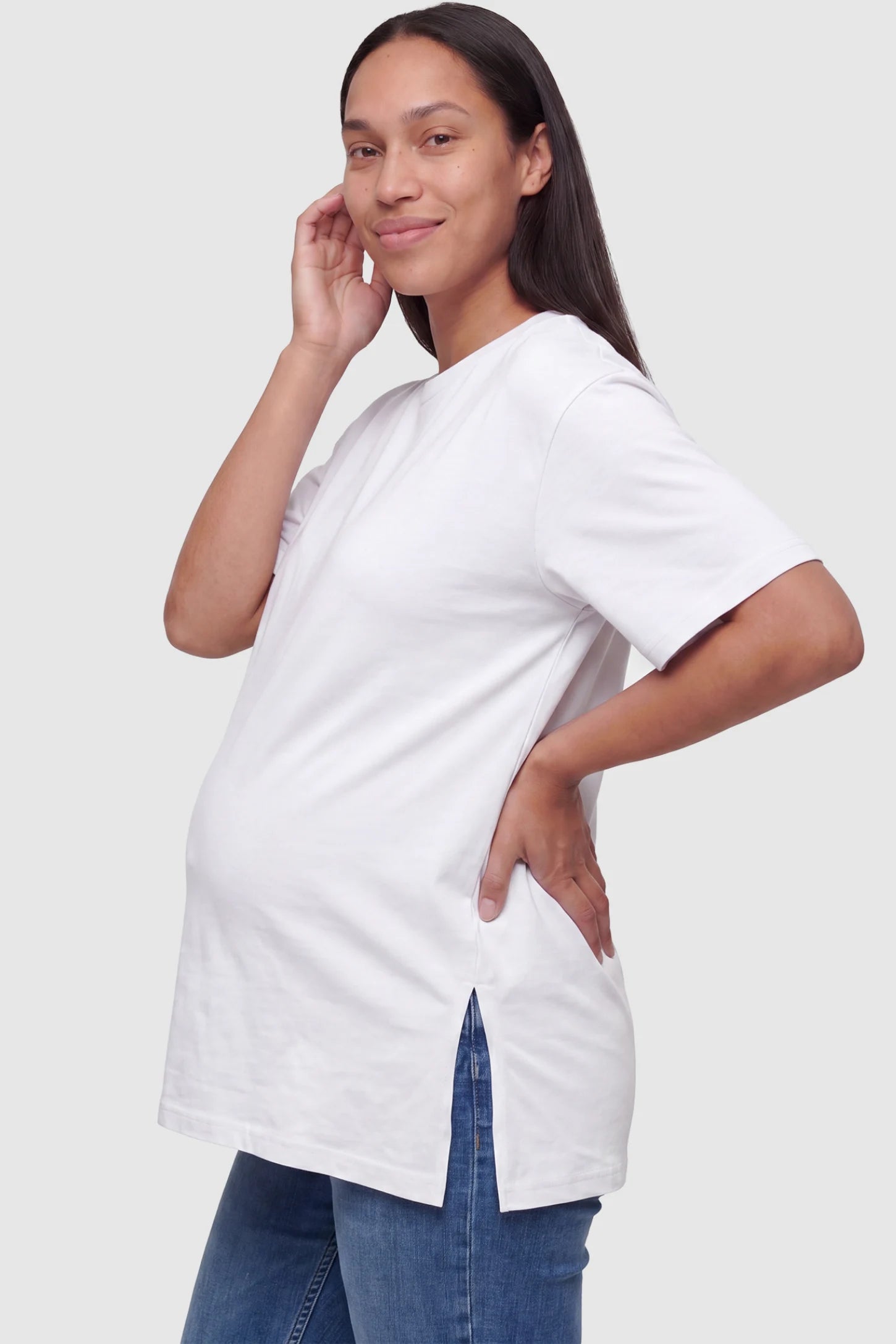 Basic One-Sided Slit Short Sleeve Maternity Top Basic one-sided slit short sleeve maternity top in white with one-sided slit, side view on pregnant model
