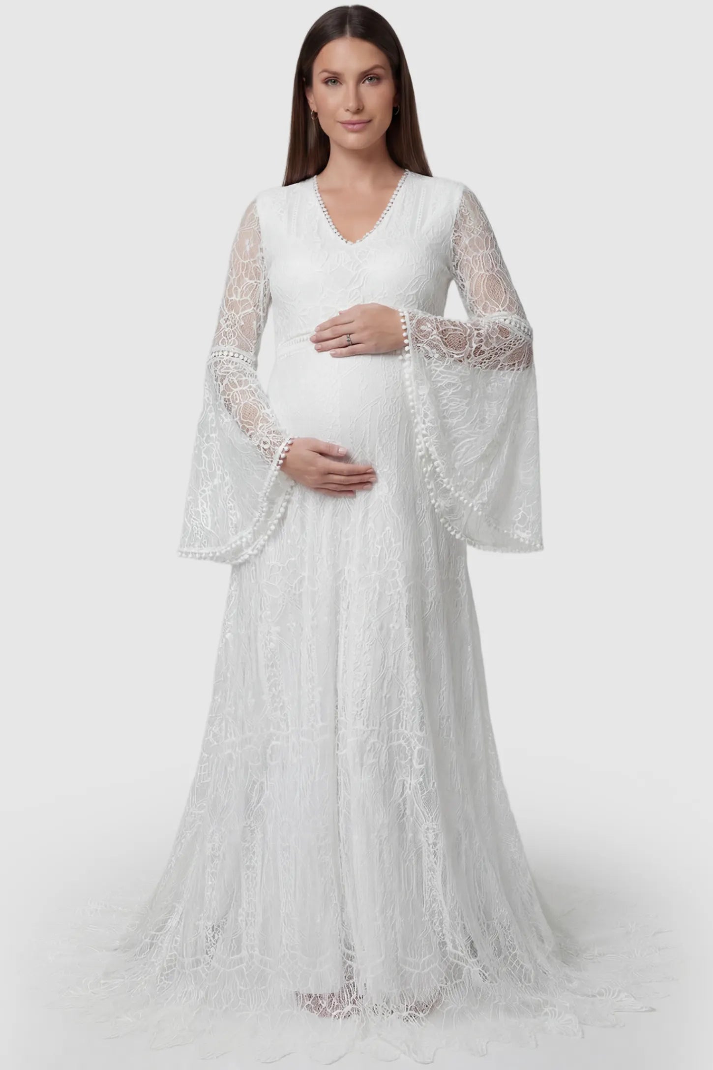 Lace Bell Sleeve Bridal Maternity Gown in white featuring scalloped lace hem and flowy back train on a pregnant model front view