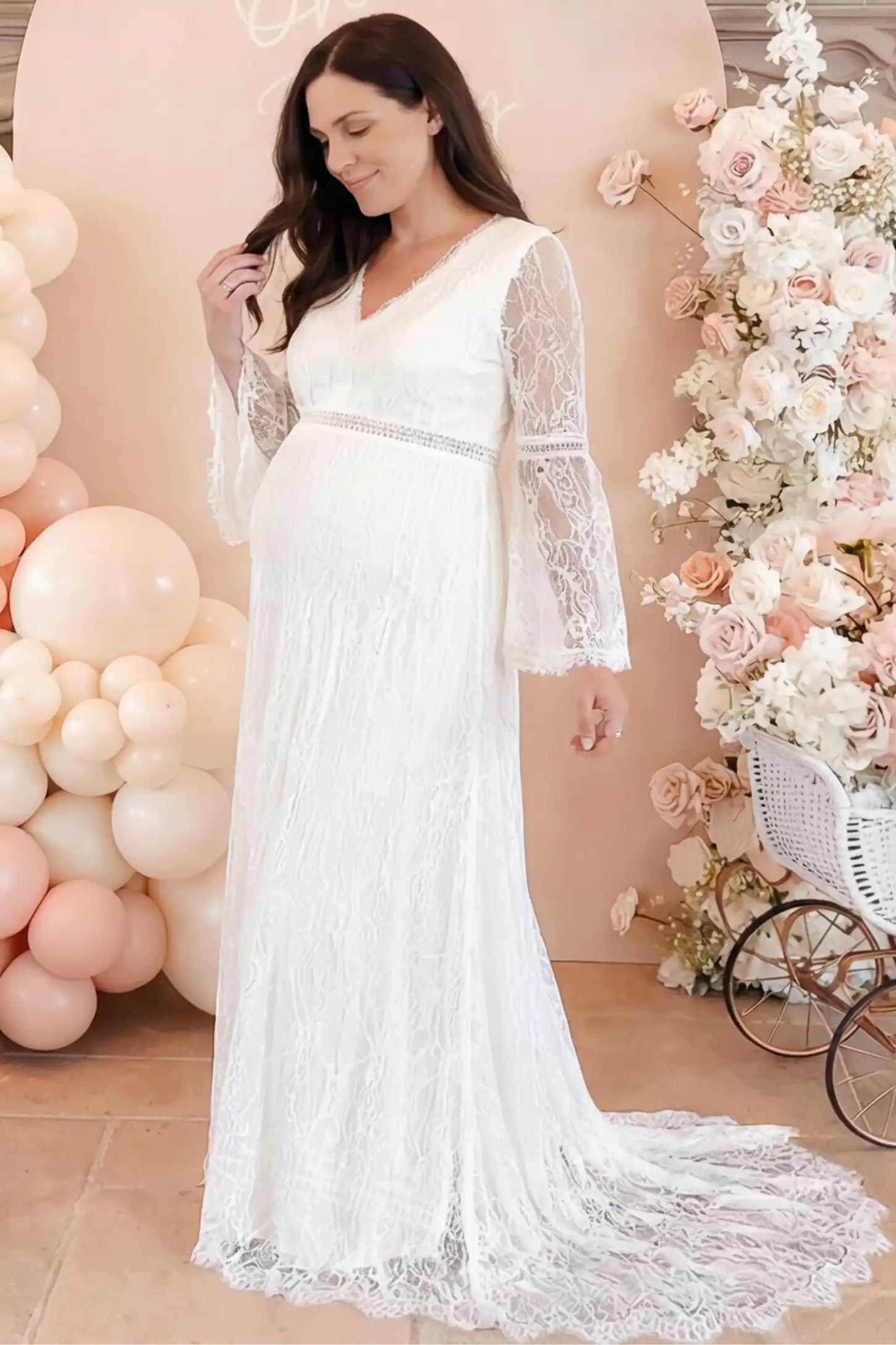 Lace Bell Sleeve Bridal Maternity Gown in white featuring scalloped lace hem and flowy back train on a pregnant model.