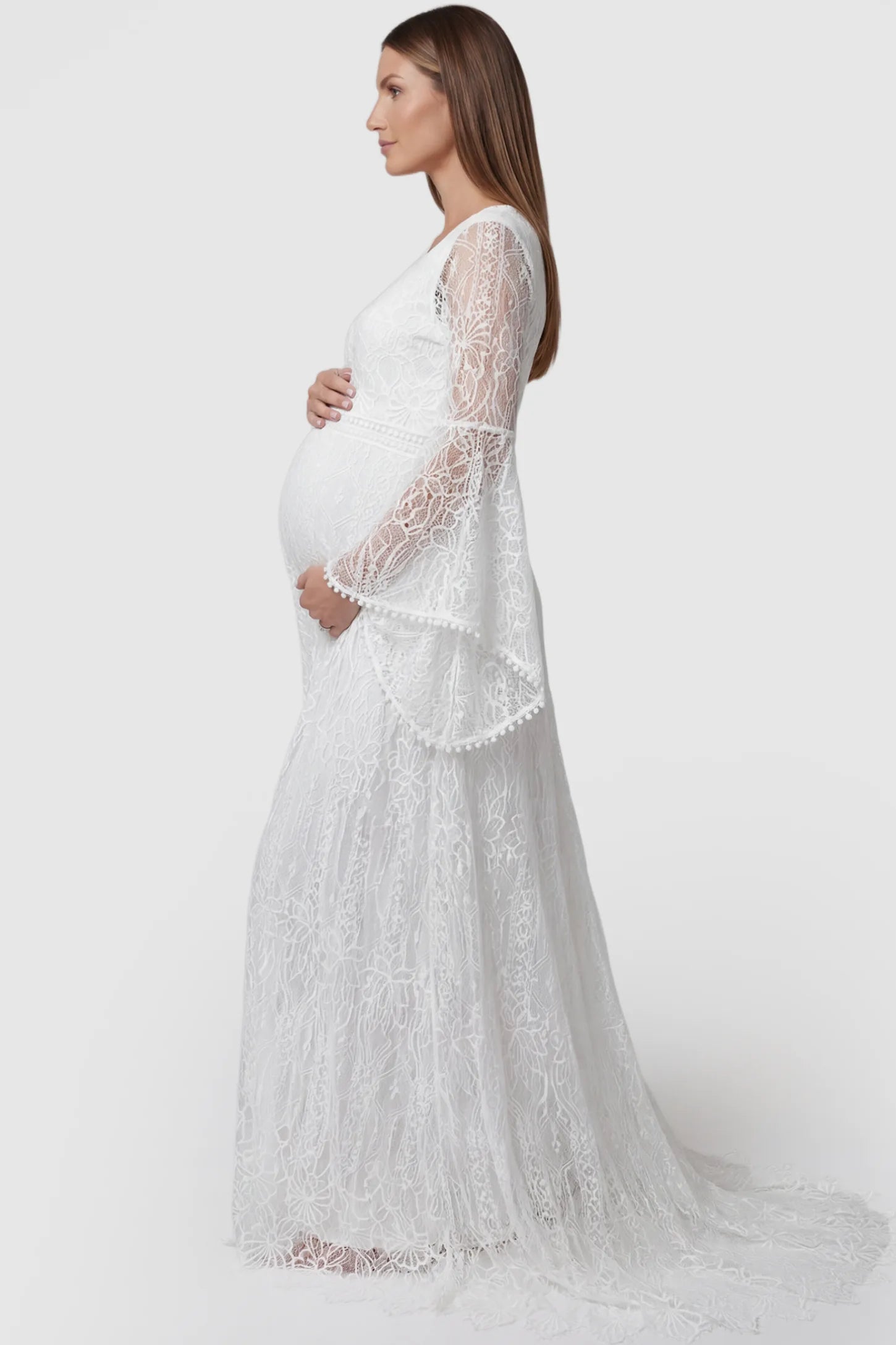 Lace Bell-Sleeve Maternity Dress Lace Bell Sleeve Bridal Maternity Gown in white featuring scalloped lace hem and flowy back train on a pregnant model side view