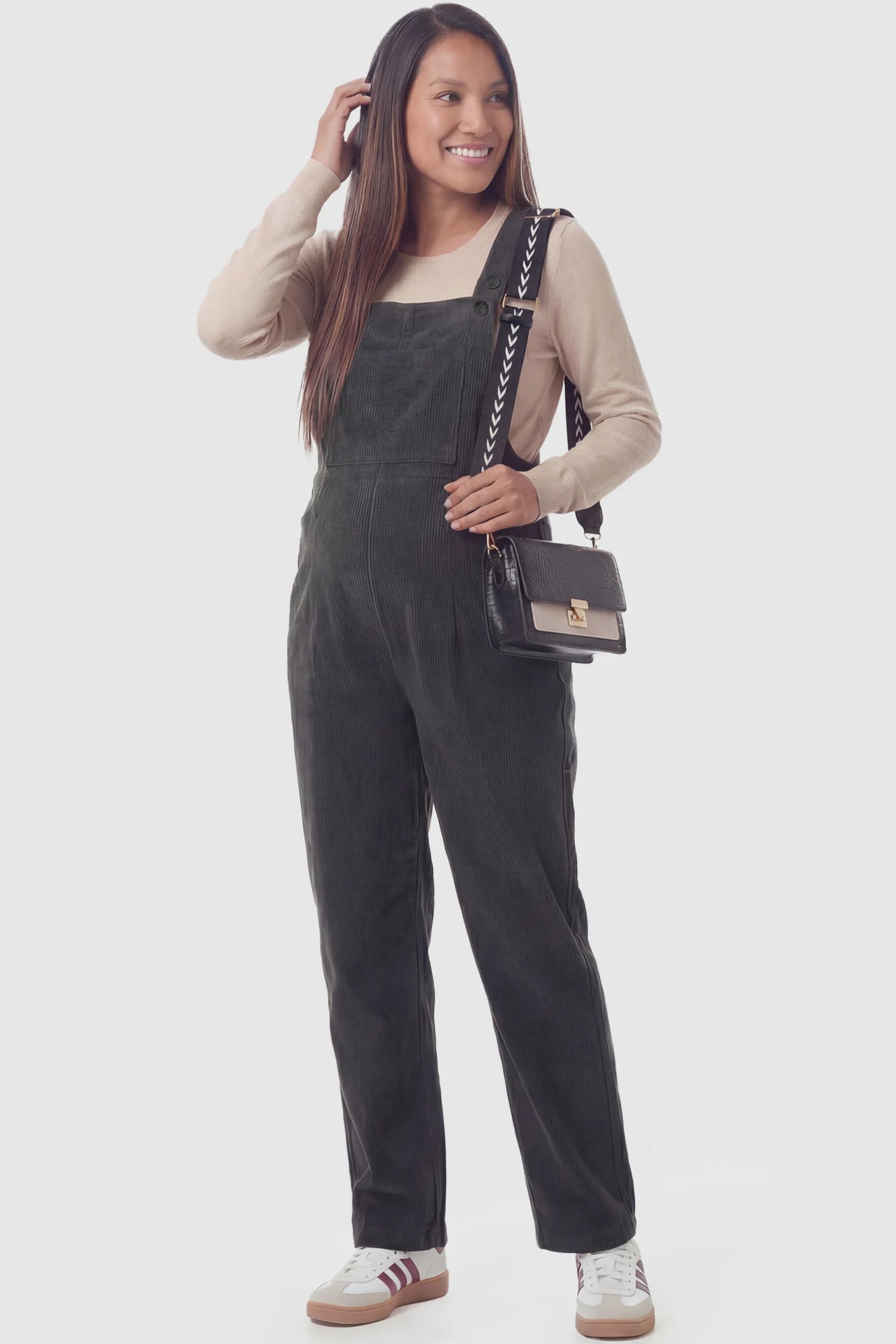 Corduroy adjustable-strap maternity overalls in gray with retro corduroy texture, front view on pregnant model