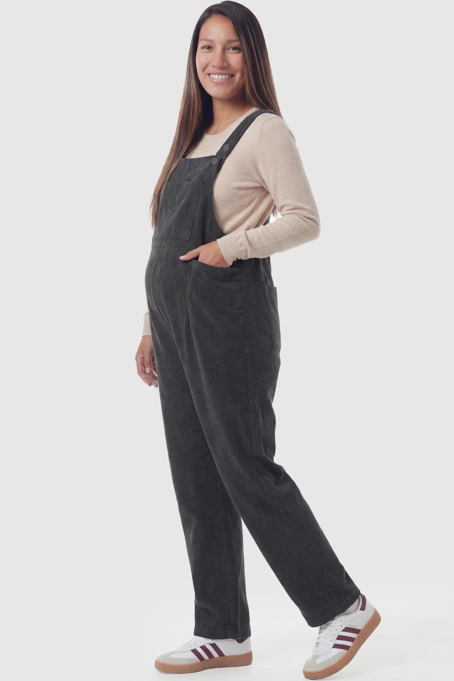 Corduroy Adjustable-Strap Maternity Overalls Corduroy adjustable-strap maternity overalls in gray with retro corduroy texture, side view on pregnant model