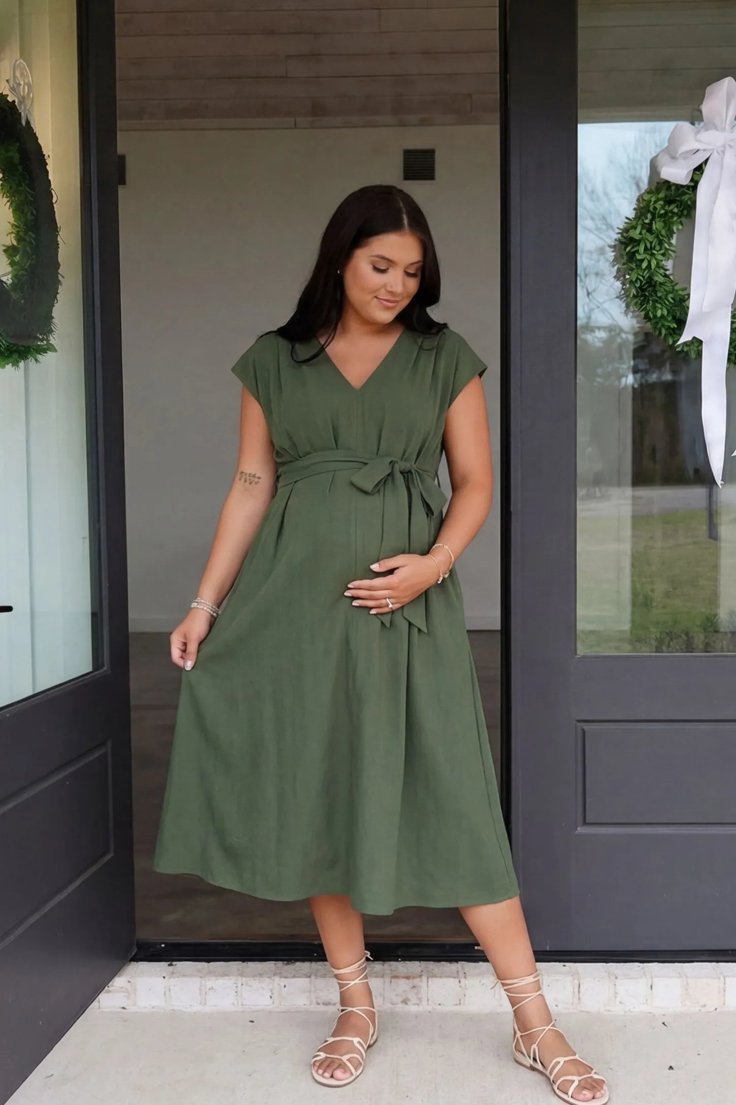 Cap Sleeves Belted Maternity Midi Dress Cap Sleeves Belted Maternity Midi Dress in army green featuring a V-neckline, cap sleeves, and a self-tie waist belt on a pregnant model.