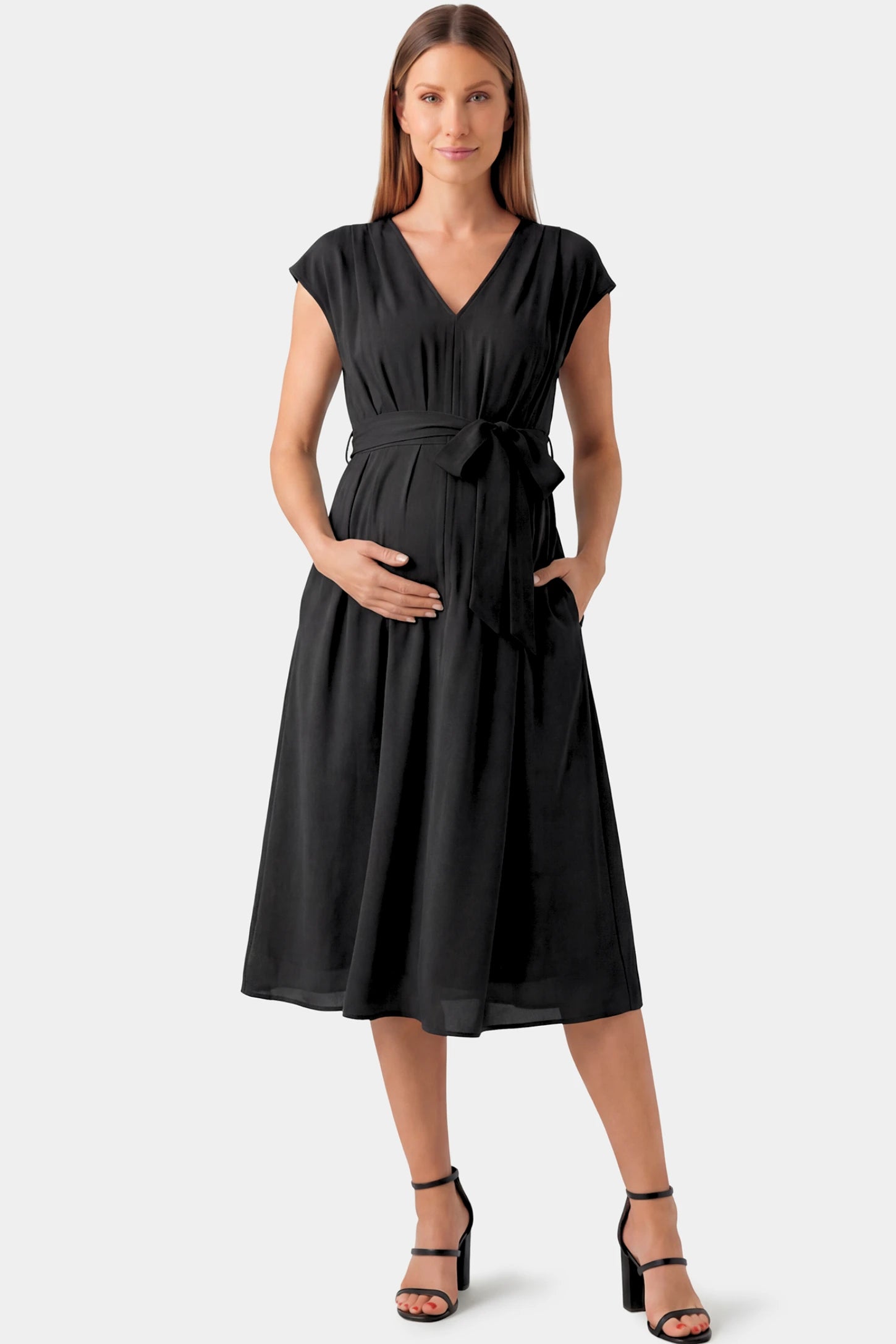 Cap Sleeves Belted Maternity Midi Dress Cap Sleeves Belted Maternity Midi Dress in black featuring a V-neckline, cap sleeves, and a self-tie waist belt on a pregnant model.