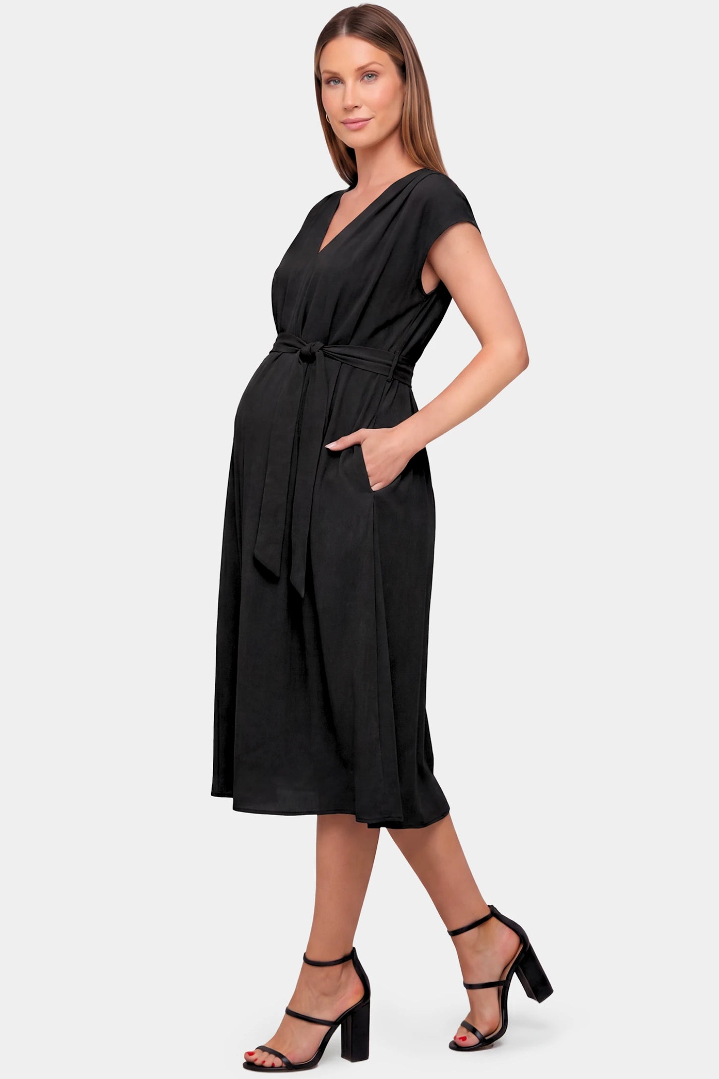 Cap Sleeves Belted Maternity Midi Dress Cap Sleeves Belted Maternity Midi Dress in black featuring a V-neckline, cap sleeves, and a self-tie waist belt on a pregnant model.