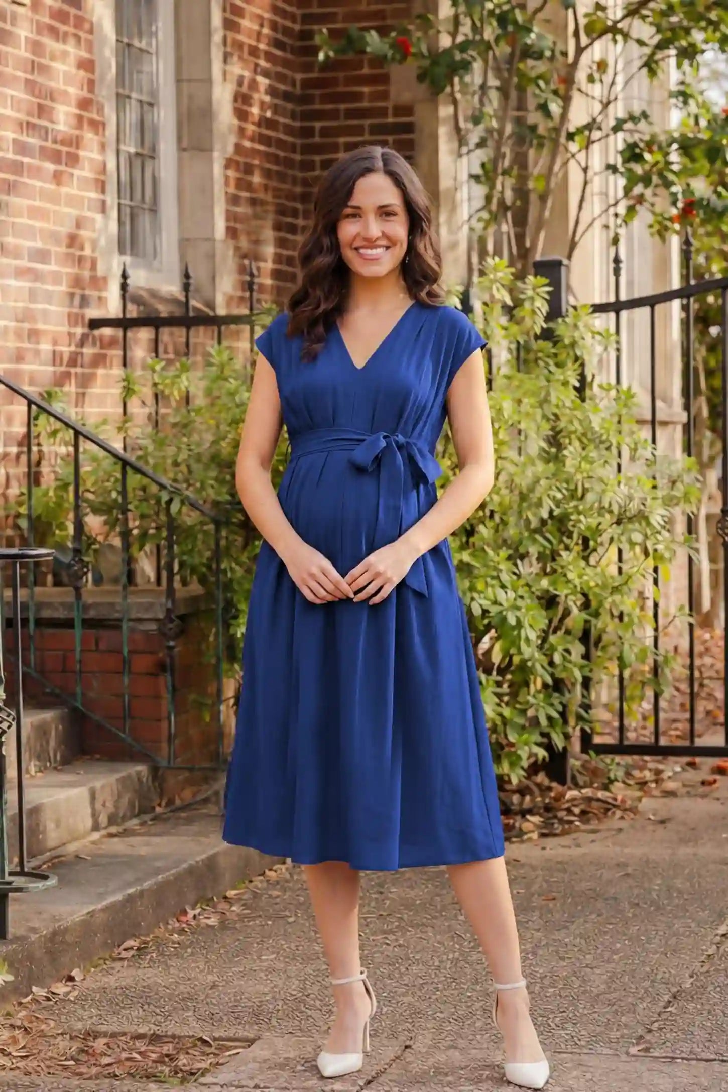 Cap Sleeves Belted Maternity Midi Dress Cap Sleeves Belted Maternity Midi Dress in blue featuring a V-neckline, cap sleeves, and a self-tie waist belt on a pregnant model.