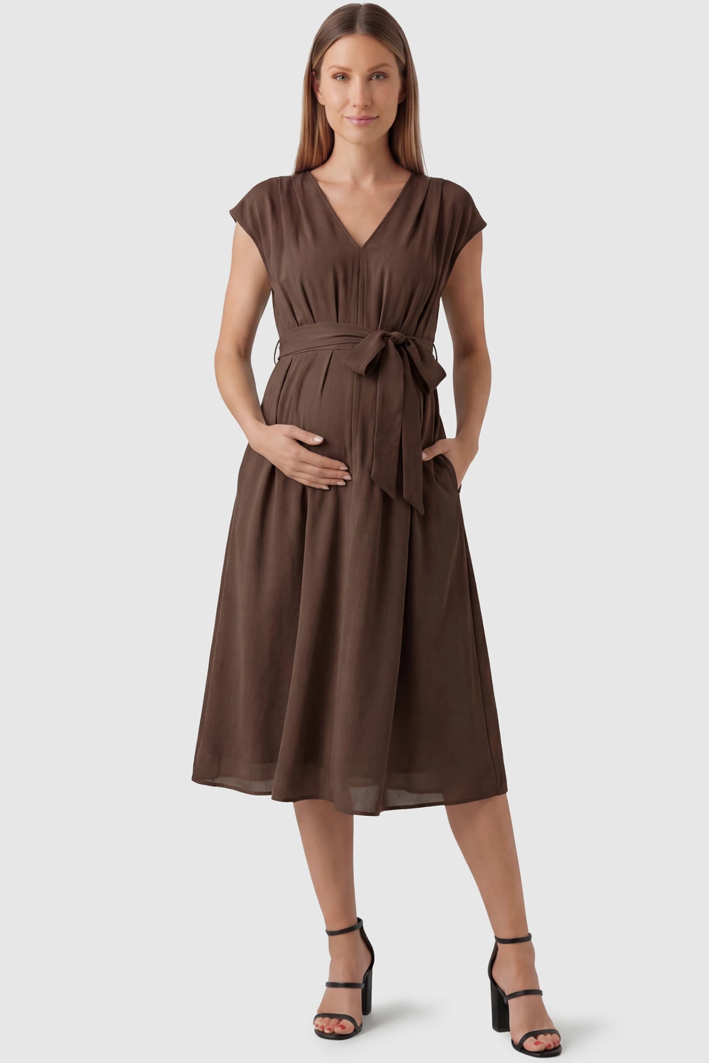 Cap Sleeves Belted Maternity Midi Dress Cap Sleeves Belted Maternity Midi Dress in coffee featuring a V-neckline, cap sleeves, and a self-tie waist belt on a pregnant model.