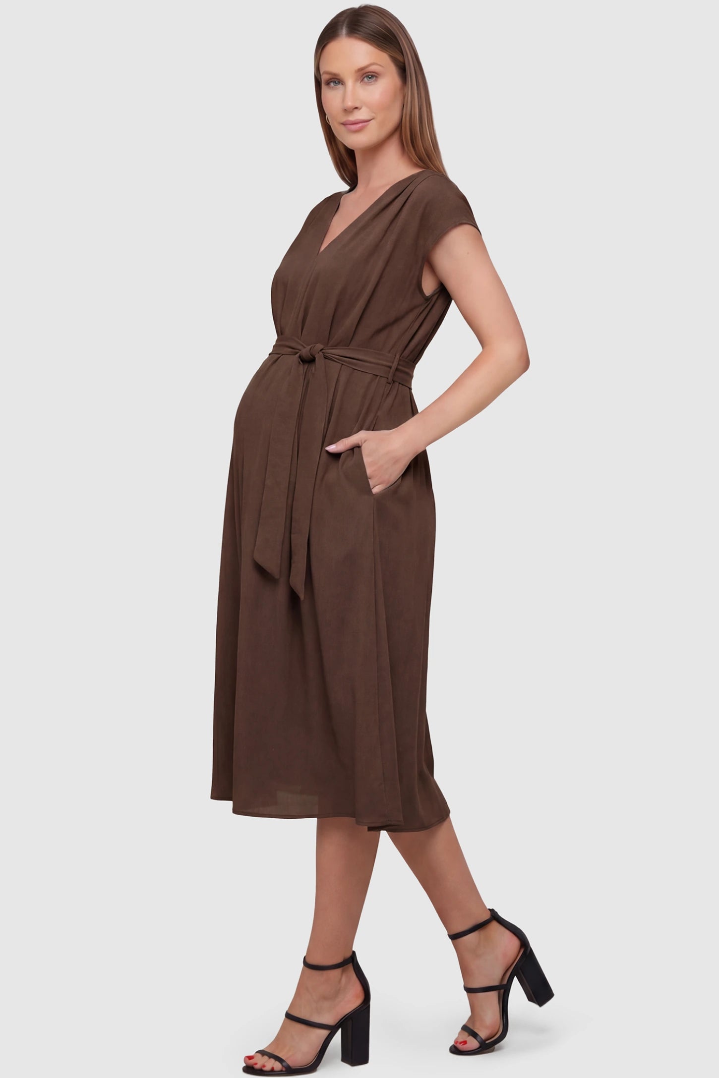 Cap Sleeves Belted Maternity Midi Dress Cap Sleeves Belted Maternity Midi Dress in coffee featuring a V-neckline, cap sleeves, and a self-tie waist belt on a pregnant model.