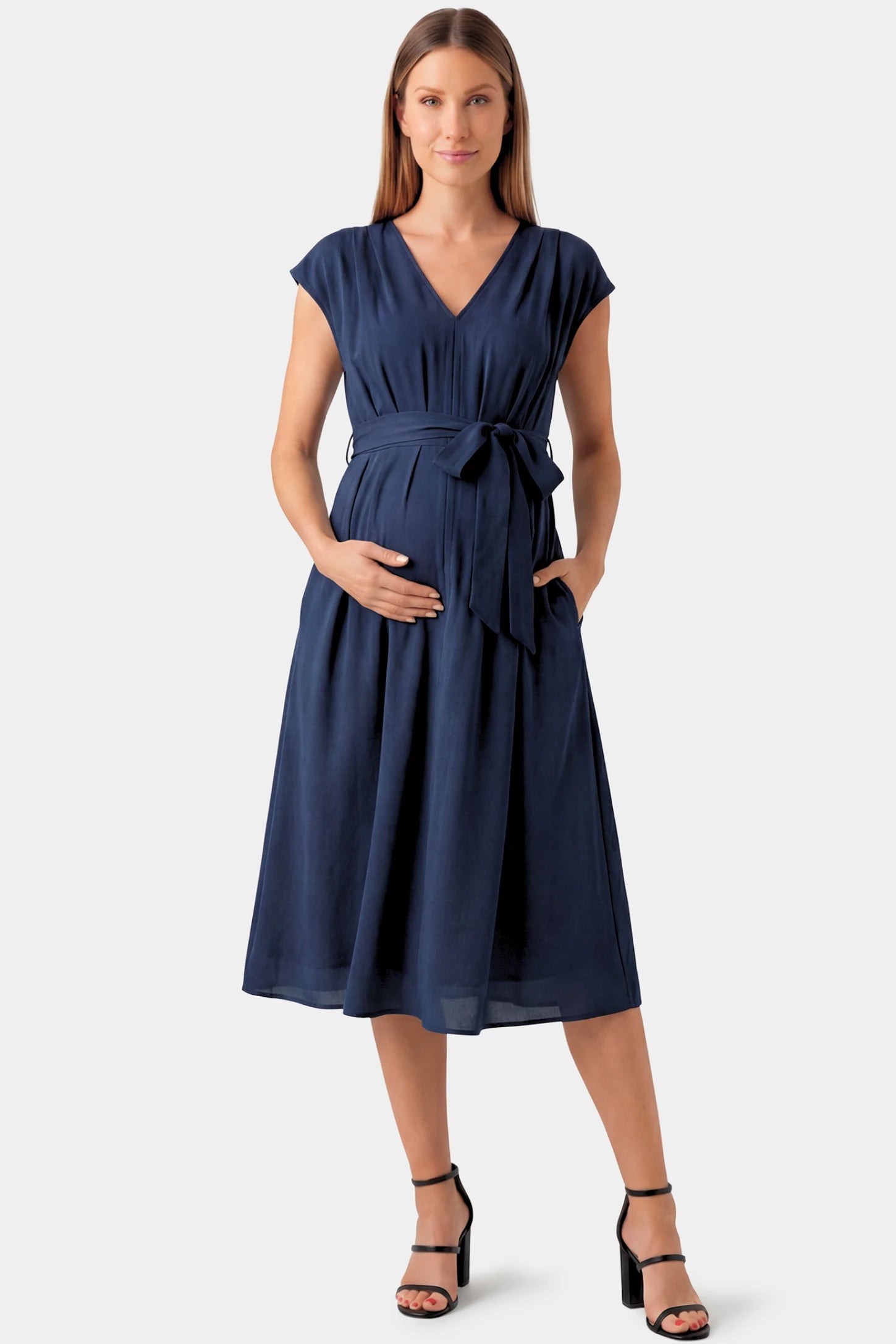 Cap Sleeves Belted Maternity Midi Dress Cap Sleeves Belted Maternity Midi Dress in navy blue featuring a V-neckline, cap sleeves, and a self-tie waist belt on a pregnant model.