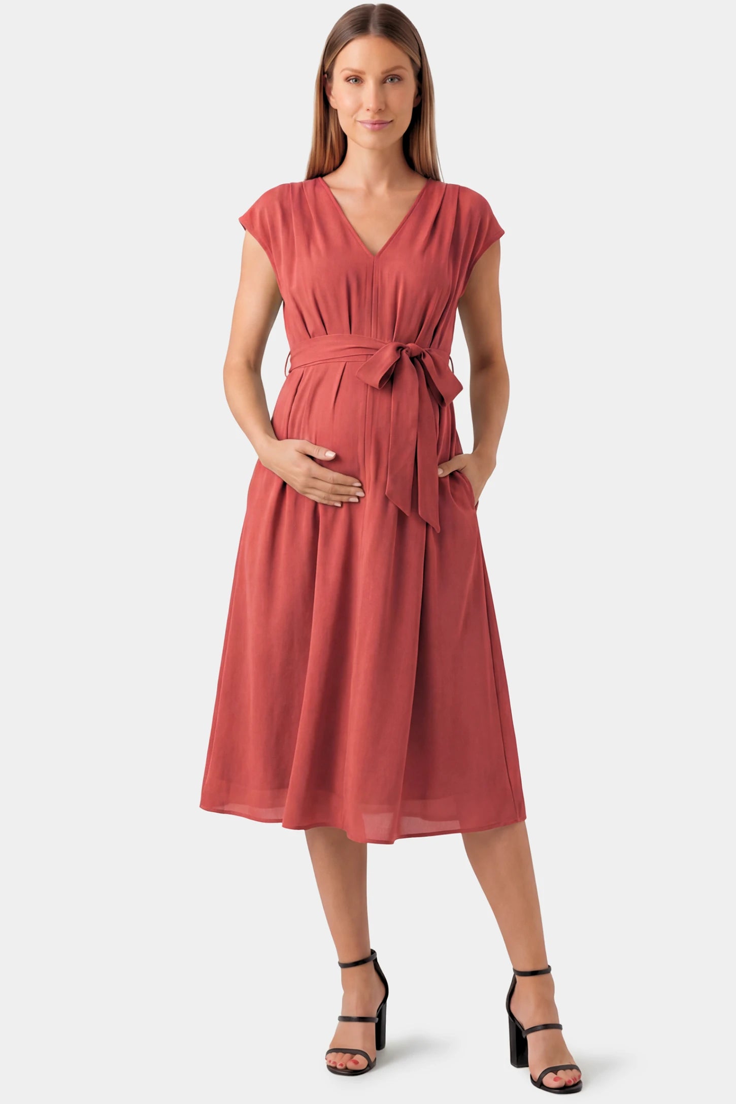 Cap Sleeves Belted Maternity Midi Dress Cap Sleeves Belted Maternity Midi Dress in orange featuring a V-neckline, cap sleeves, and a self-tie waist belt on a pregnant model.