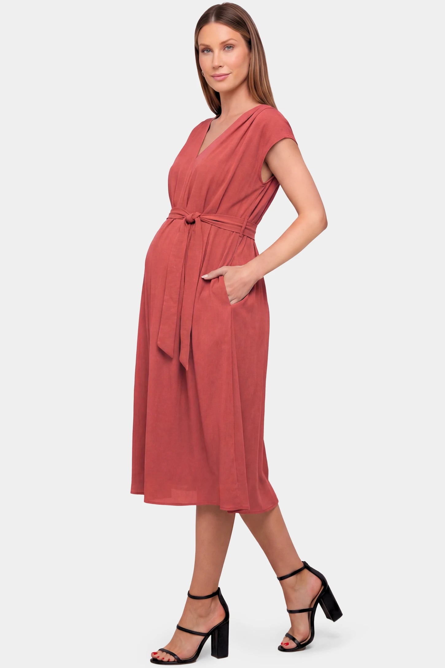 Cap Sleeves Belted Maternity Midi Dress Cap Sleeves Belted Maternity Midi Dress in orange featuring a V-neckline, cap sleeves, and a self-tie waist belt on a pregnant model.