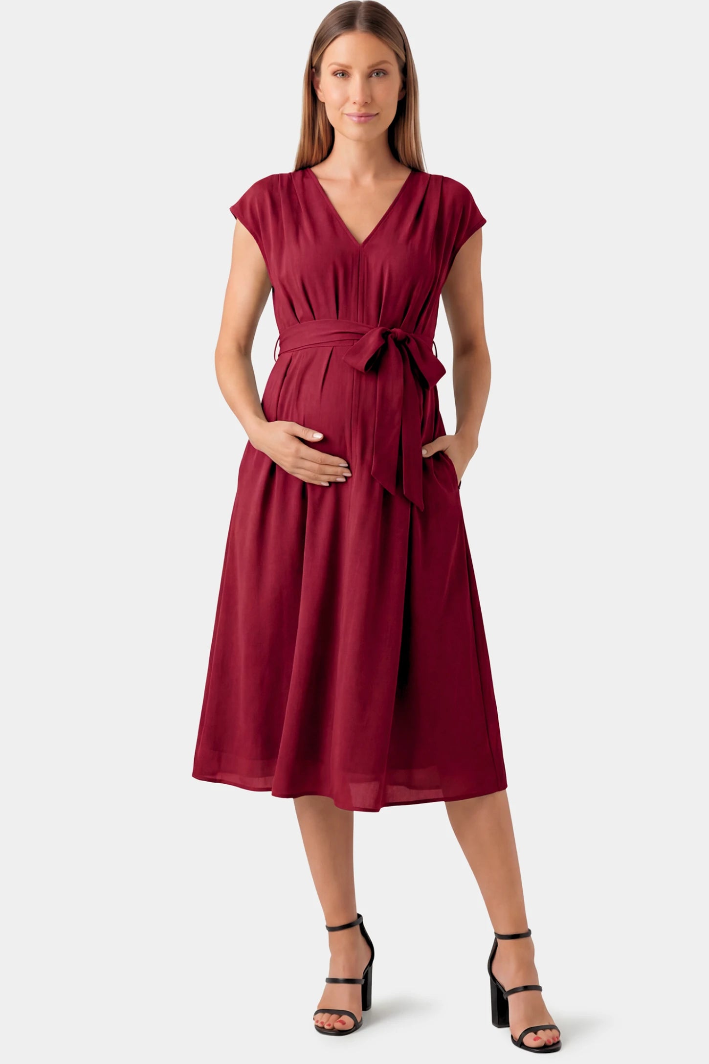 Cap Sleeves Belted Maternity Midi Dress in wine red featuring a V-neckline, cap sleeves, and a self-tie waist belt on a pregnant model.