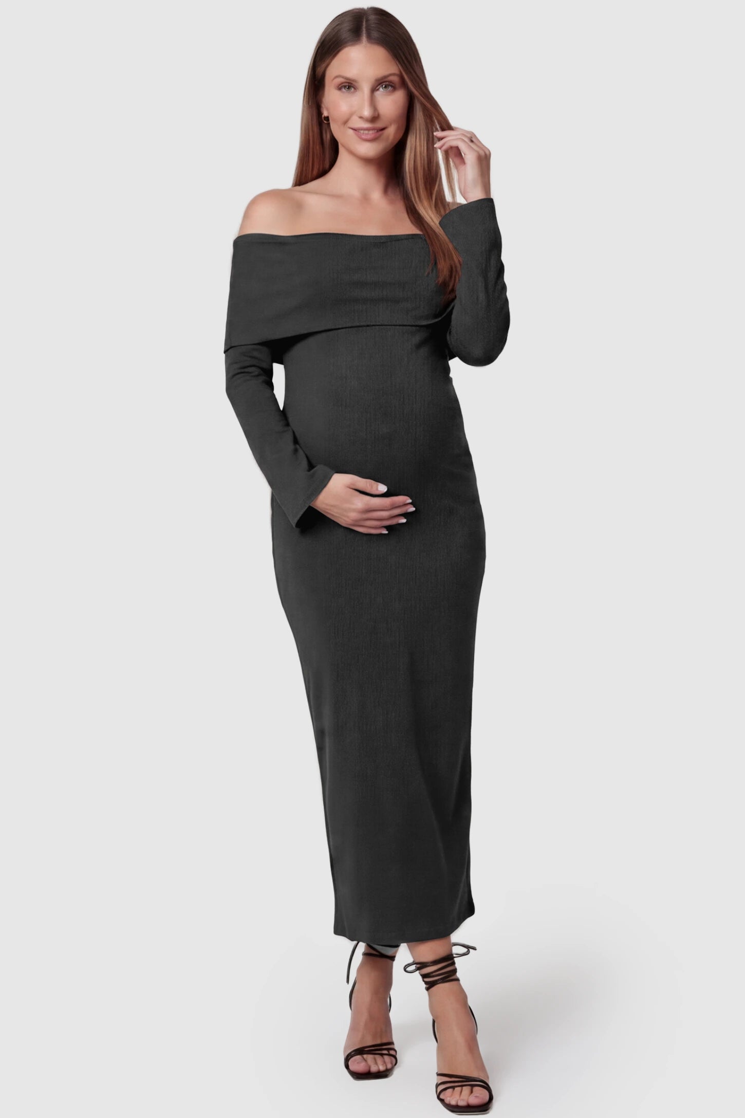 Ruched off-shoulder bodycon maternity midi dress in black with off-shoulder neckline, front view on pregnant model