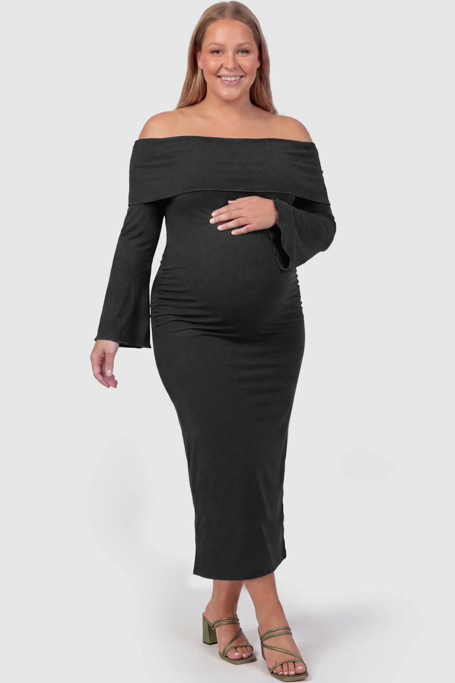 Ruched Off-shoulder Bodycon Maternity Midi Dress Ruched off-shoulder bodycon maternity midi dress in black with off-shoulder neckline, front view on plus-size model