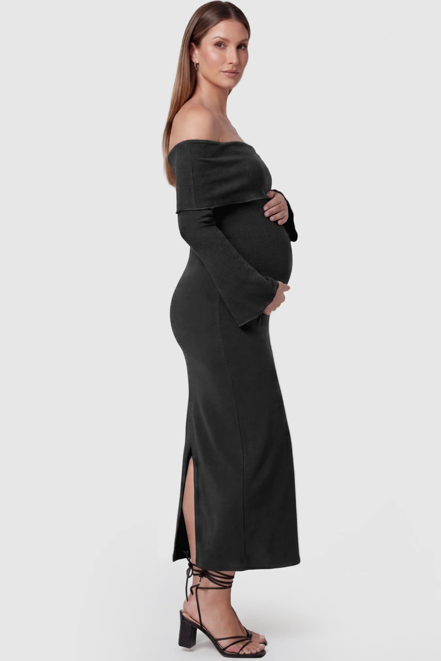 Ruched Off-shoulder Bodycon Maternity Midi Dress Ruched off-shoulder bodycon maternity midi dress in black with ruched side detailing, side view on pregnant model