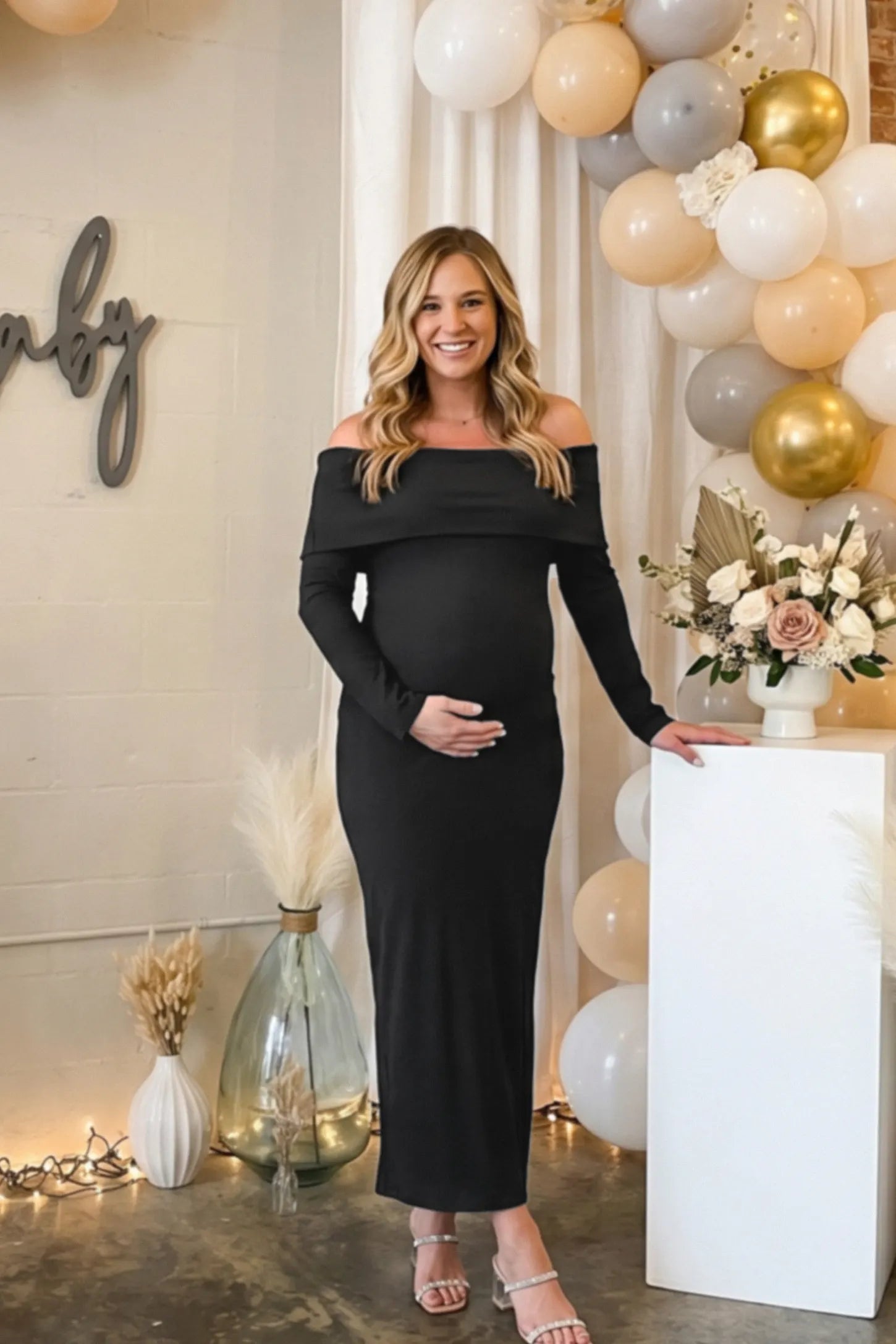 Ruched Off-shoulder Bodycon Maternity Midi Dress Ruched off-shoulder bodycon maternity midi dress in black with off-shoulder neckline, front view on pregnant model