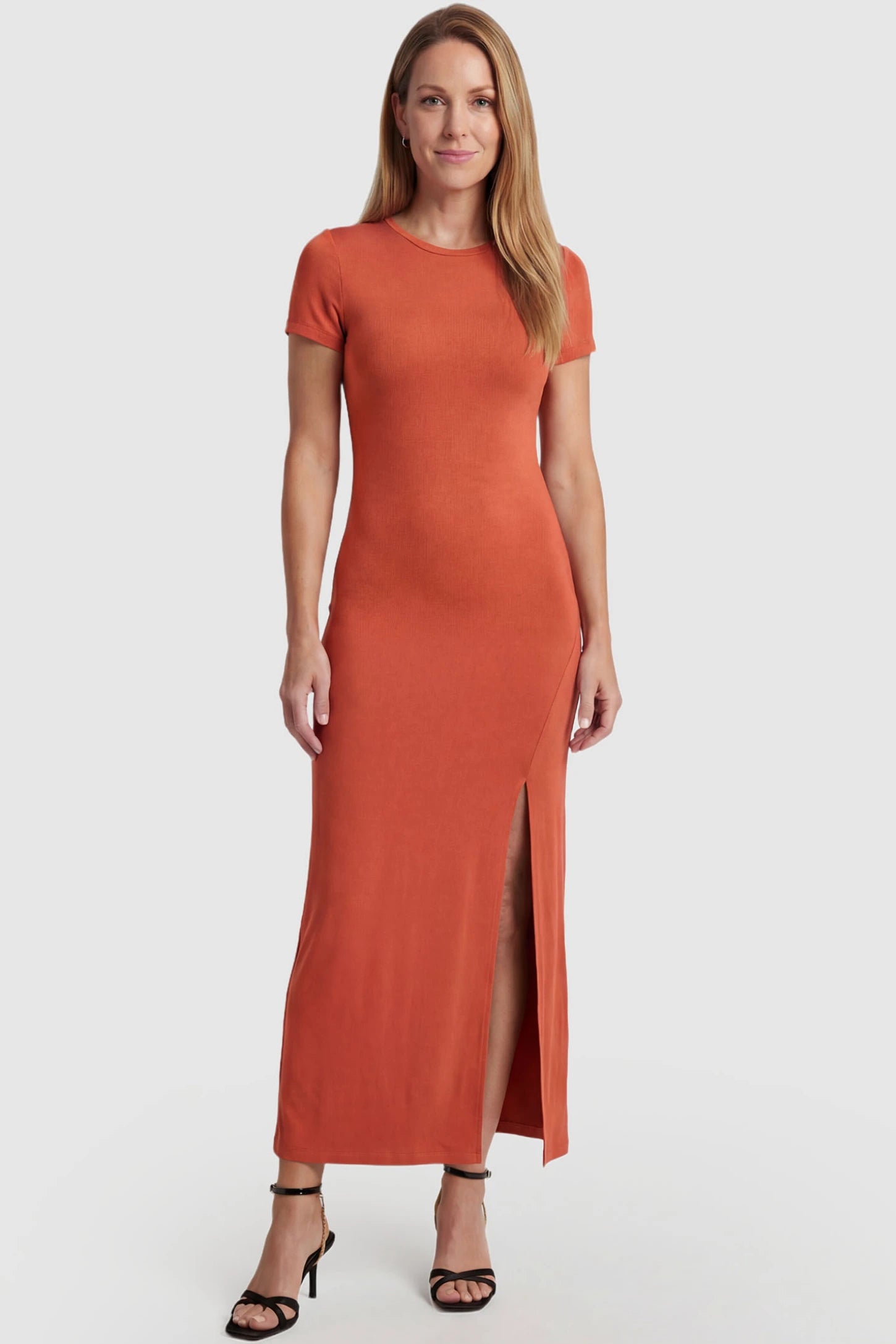 Short Sleeve Round Neck Bodycon Maxi Maternity Dress Short sleeve round neck bodycon maxi maternity dress in orange featuring simple round neckline and high-slit in front view on a postpartum model