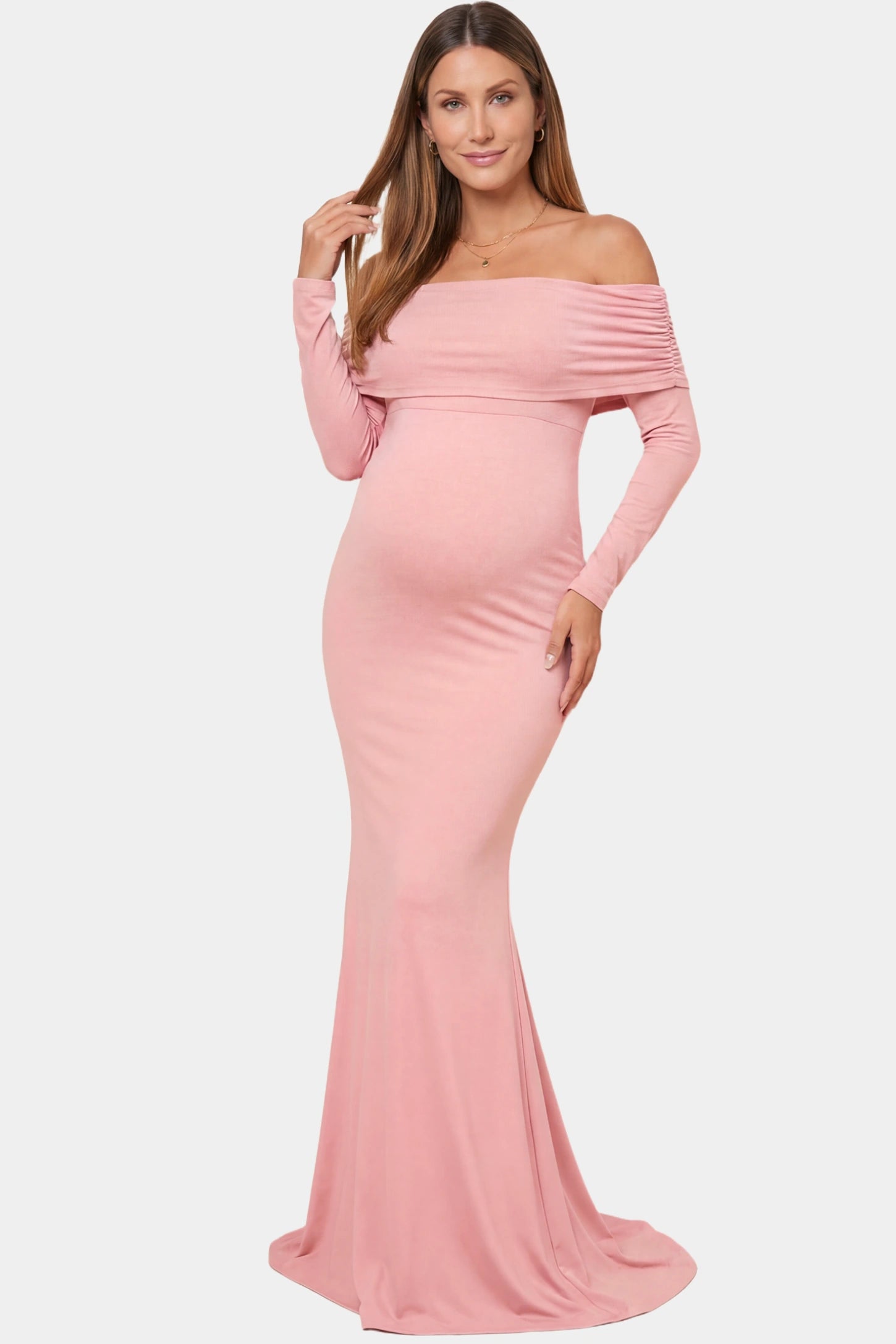 Off-the-shoulder long sleeve bodycon maxi maternity dress in pink featuring fitted silhouette in full body front view on a pregnant model