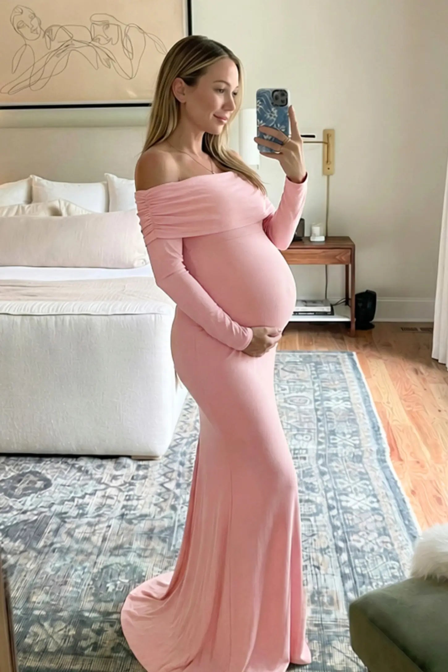 Off-the-Shoulder Long Sleeve Bodycon Maxi Maternity Dress Off-the-shoulder long sleeve bodycon maxi maternity dress in pink featuring fitted silhouette in full body view on a pregnant model