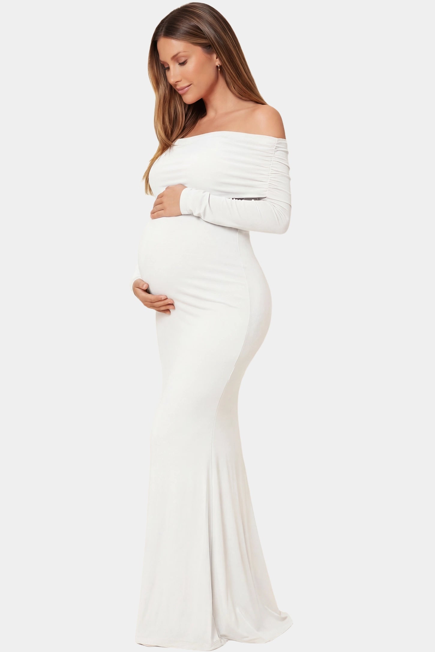 Off-the-Shoulder Long Sleeve Bodycon Maxi Maternity Dress Off-the-shoulder long sleeve bodycon maxi maternity dress in white featuring fitted silhouette in full body side view on a pregnant model