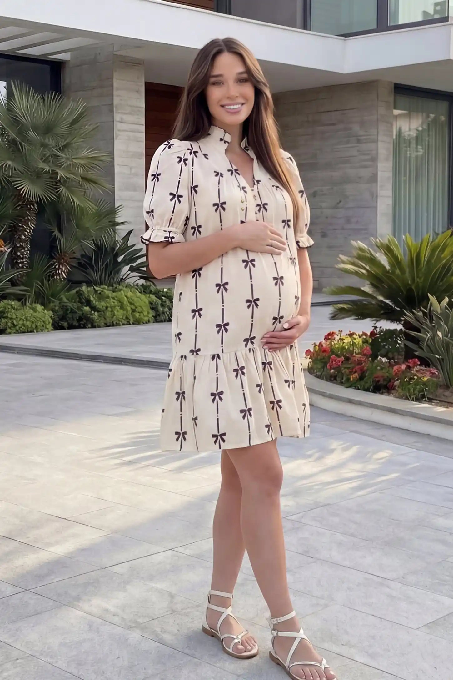Bowknot print button-up neck maternity short dress in beige with bowknot print detail, editorial lifestyle view