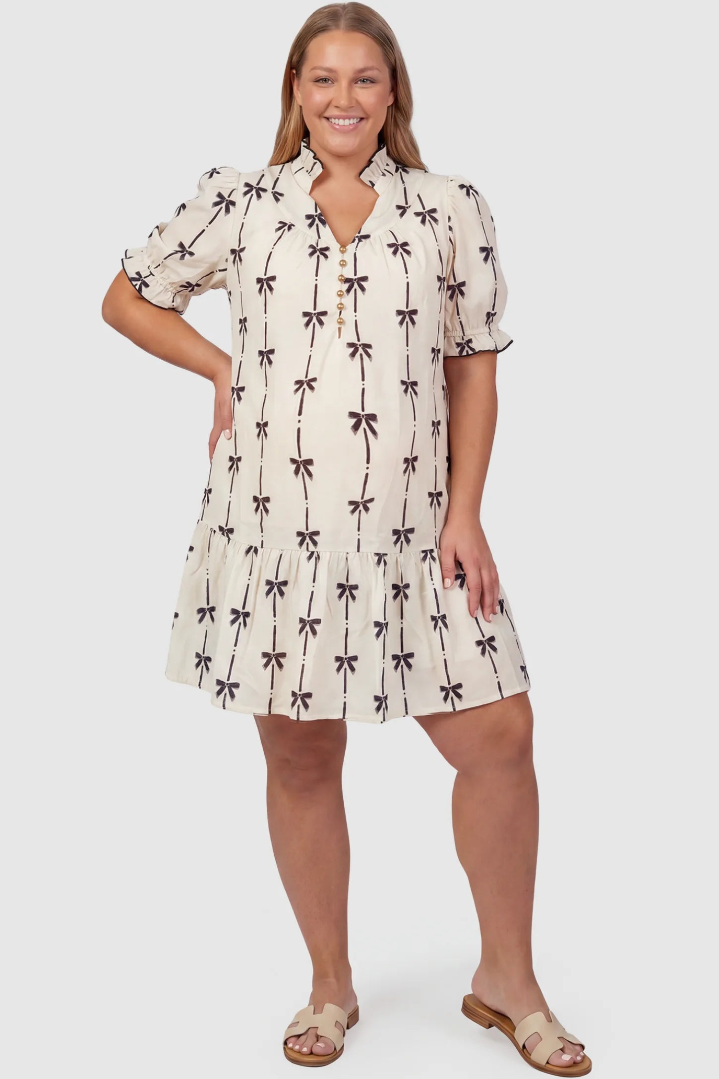 Bowknot Print Button-Up Neck Maternity Short Dress Bowknot print button-up neck maternity short dress in beige with bowknot print detail, front view on plus-size model