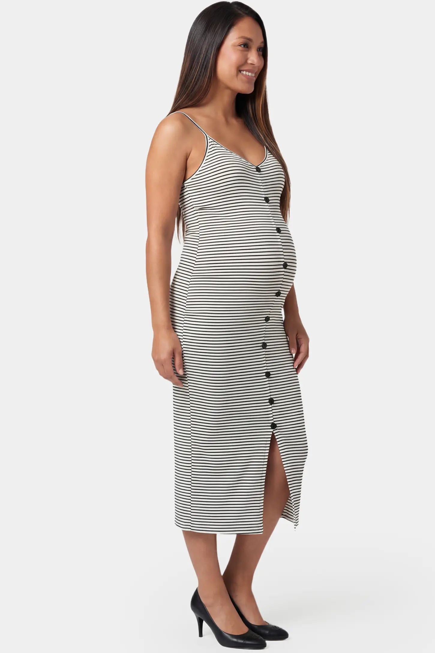 Sleeveless button-down split hem midi maternity dress in gray and white stripes featuring chic split hem in side view on a pregnant model